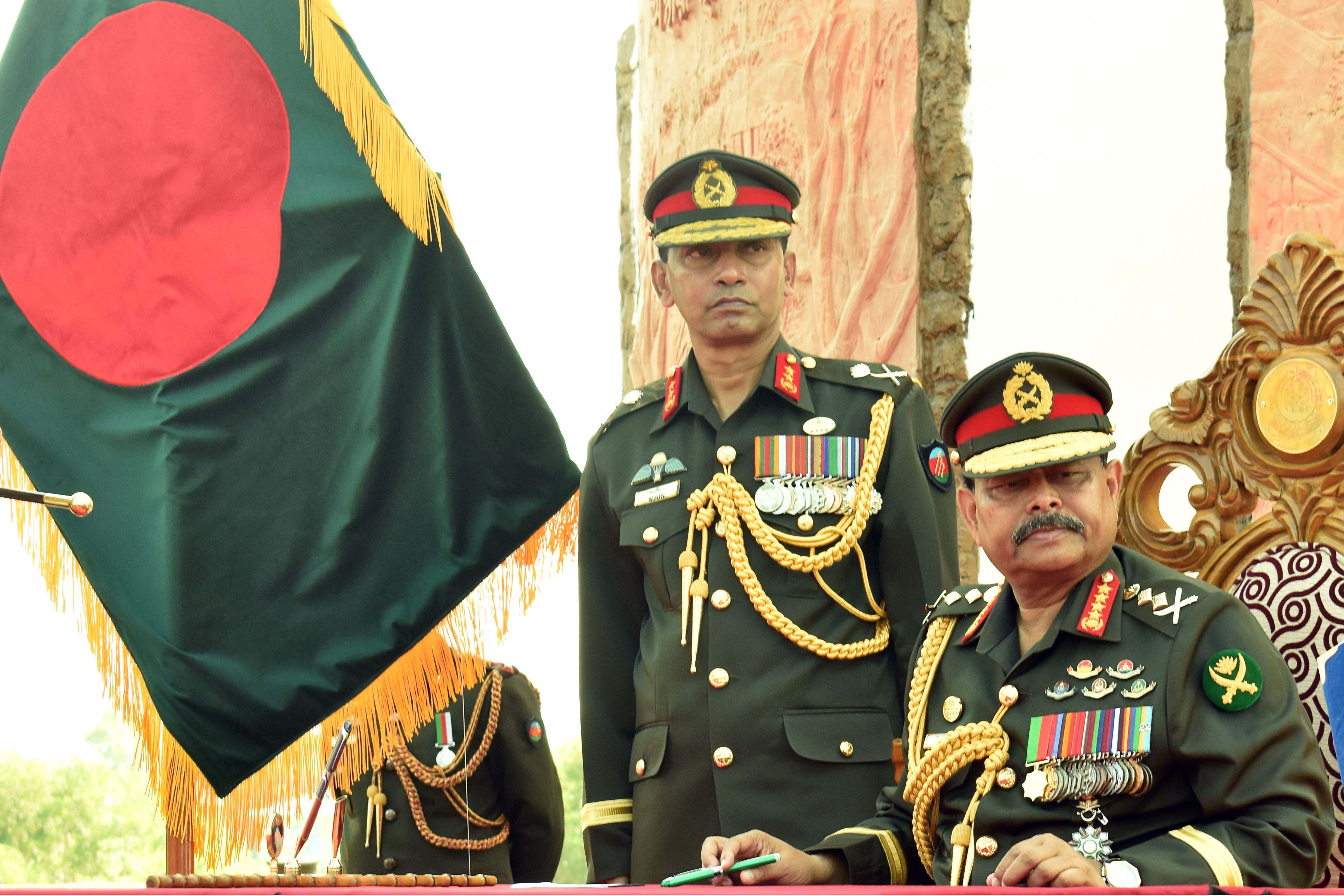Army chief General Aziz Ahmed (R) looks on during a program in a refugee camp in Ukhia on November 24, 2019.