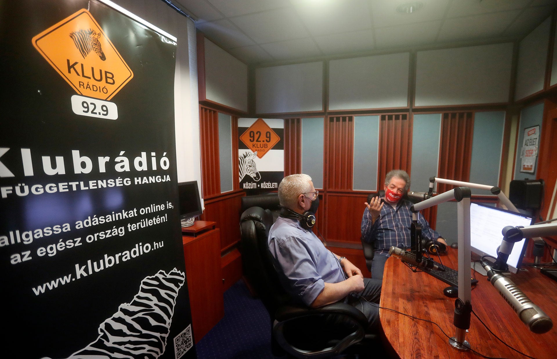 Klubradio's director and CEO Andras Arato, right, talks to colleague Milhaly Hardy in the studio of Klubradio in Budapest, Tuesday, Feb. 9, 2021.