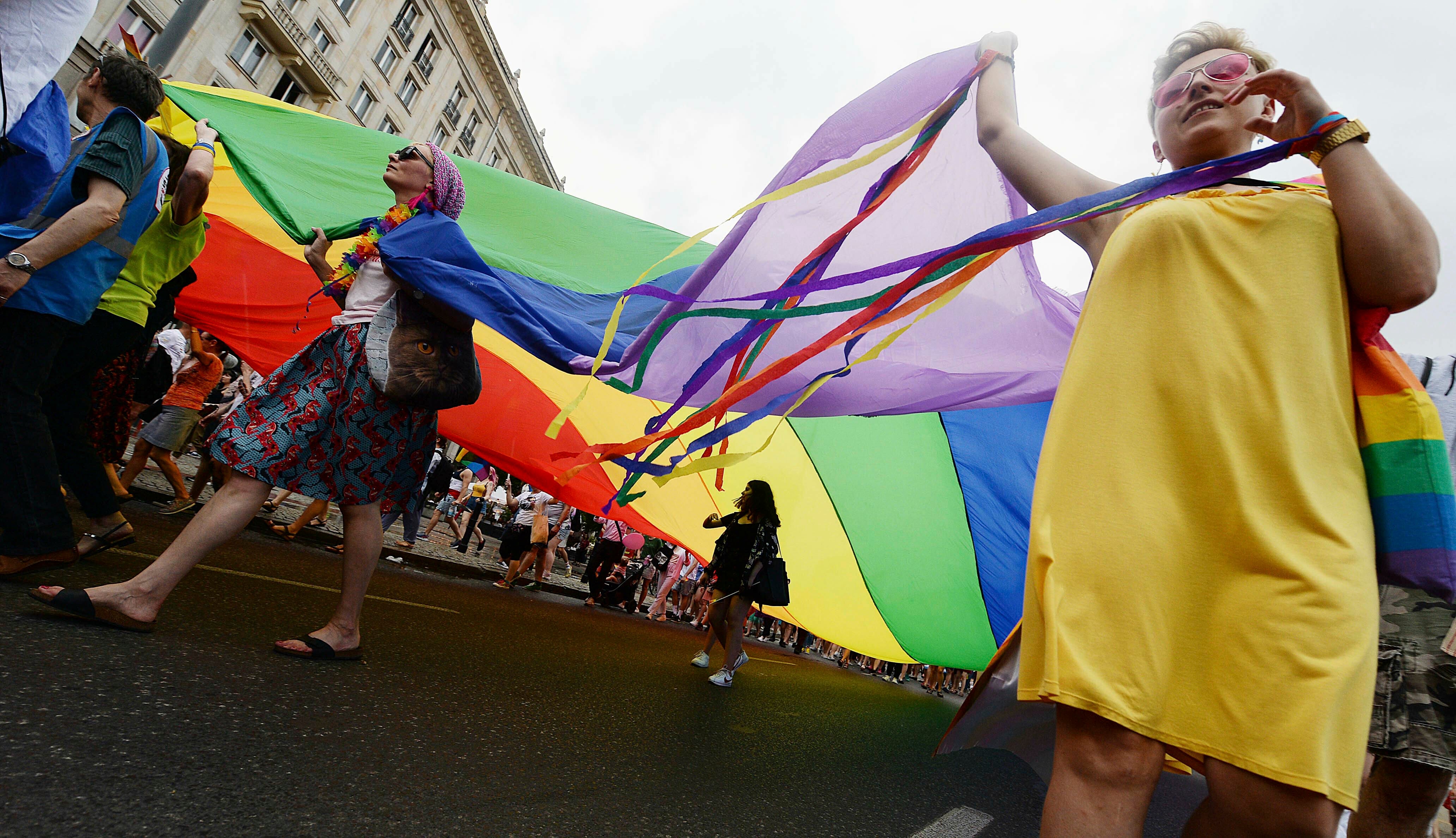 People take part in a gay pride parade in Warsaw, Poland, Saturday, June 8, 2019.