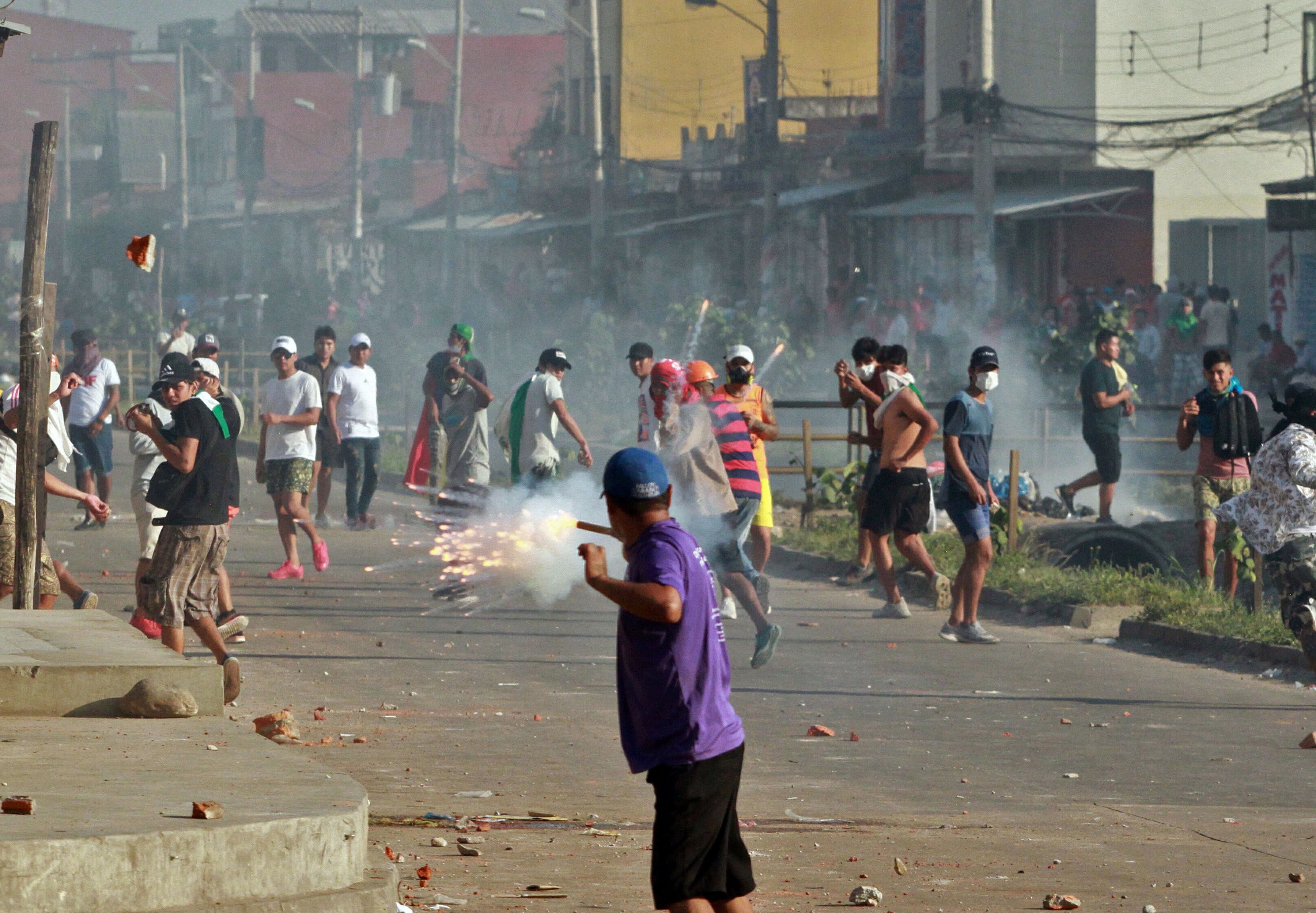 Supporters of Bolivian opposition candidate Carlos Mesa and of then President Evo Morales clash during a demonstration over disputed electoral results, in Santa Cruz, Bolivia, on October 23, 2019.