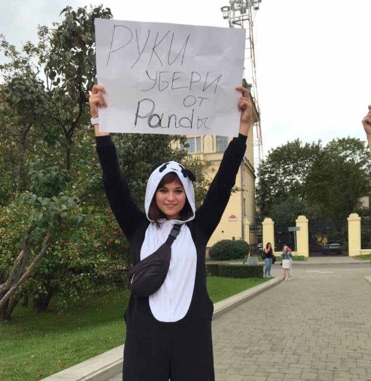 Journalist Evgeniya Dolgaya holds a poster “hands off pandas” in support of the defendants in the so-called PandaDoc case. The court’s ruling says Dolgaya “called for fair elections while wearing a panda costume.” August 29, 2020.