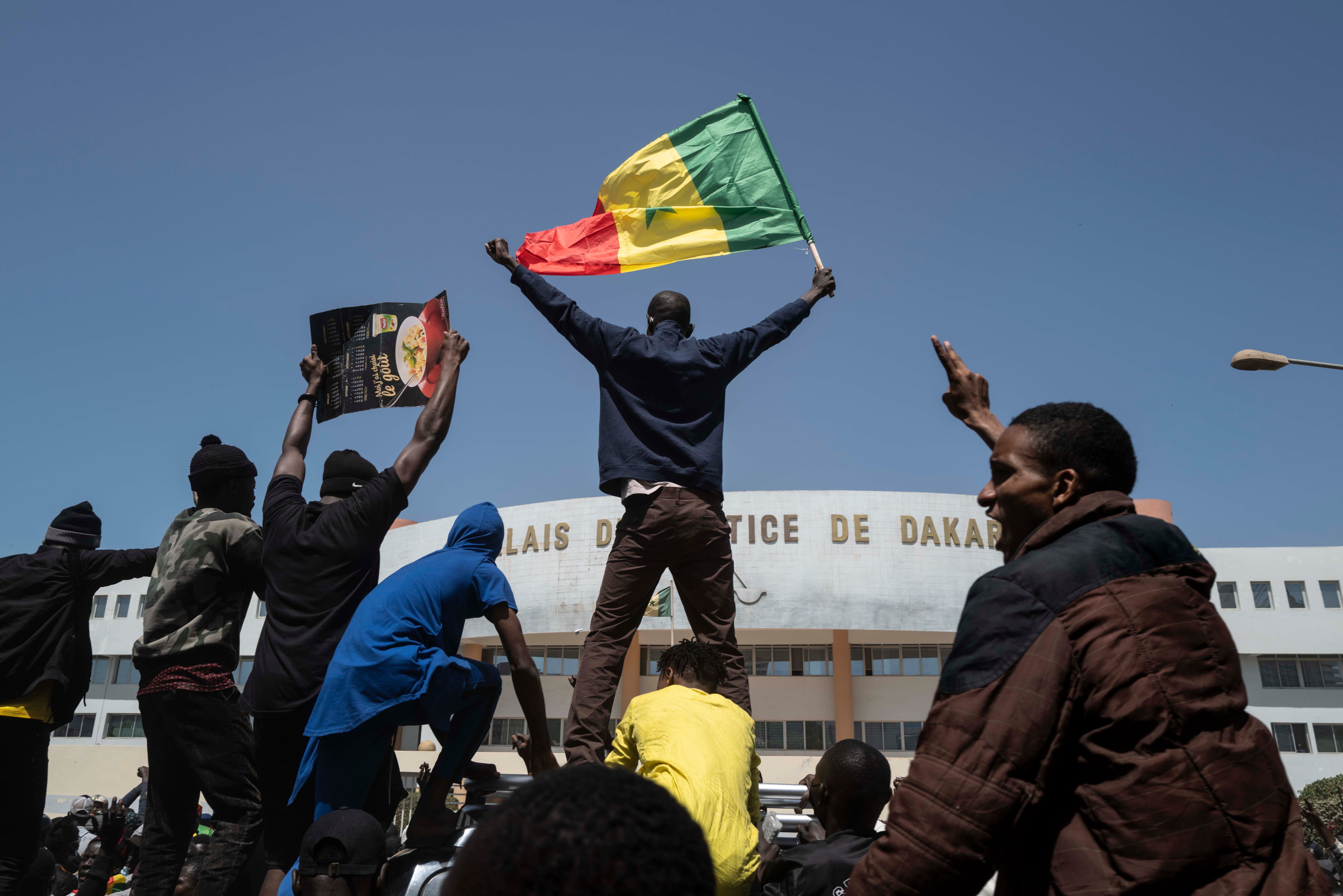 Demonstrators shout slogans during a protest against the arrest of opposition leader and former presidential candidate Ousmane Sonko near the Justice Palace of Dakar, Senegal, March 8, 2021. 