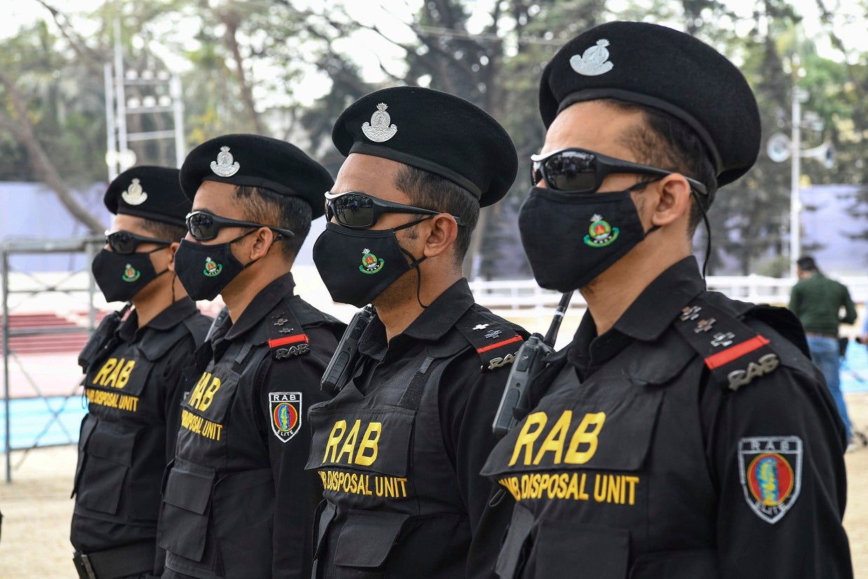 Bangladeshi RAB (Rapid Action Battalion) Dog squad unit stand on guard at the Central Shaheed Minar in Dhaka, Bangladesh. 