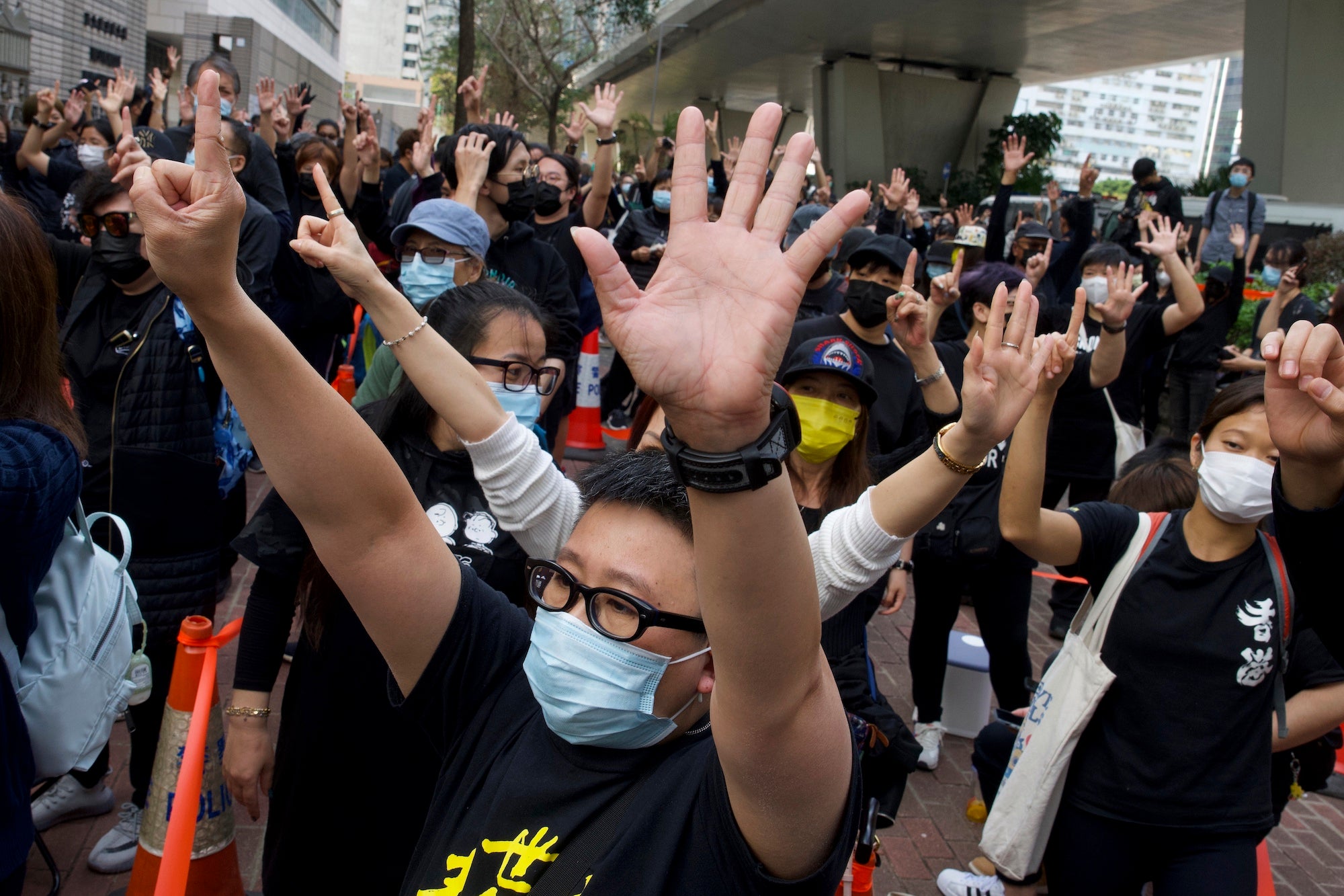 Supporters protest outside a court in Hong Kong where police brought 47 pro-democracy activists, March 1, 2021.