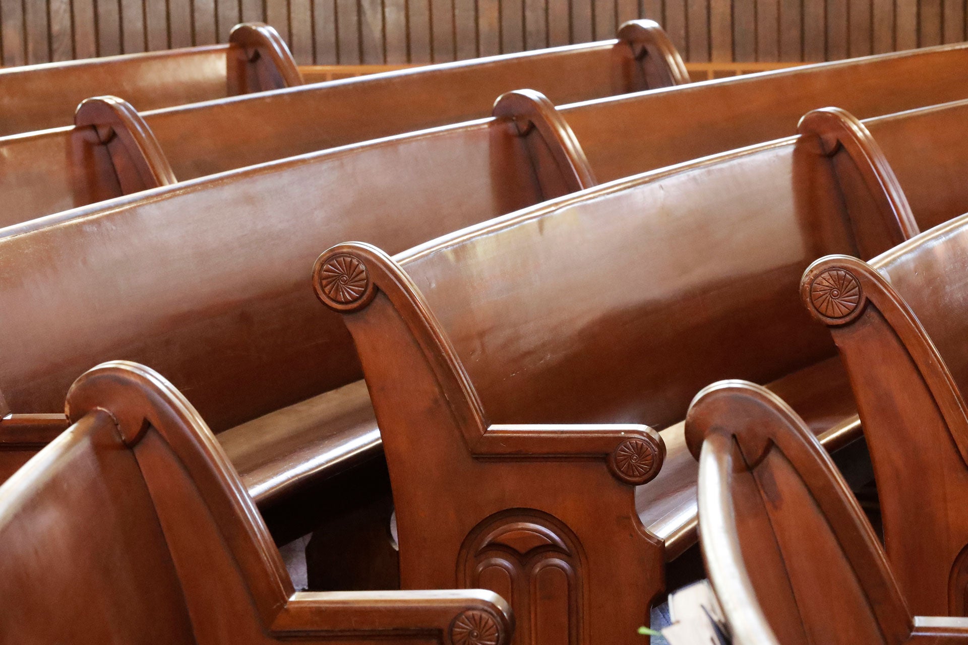 Curved pews are seen inside of a church. 
