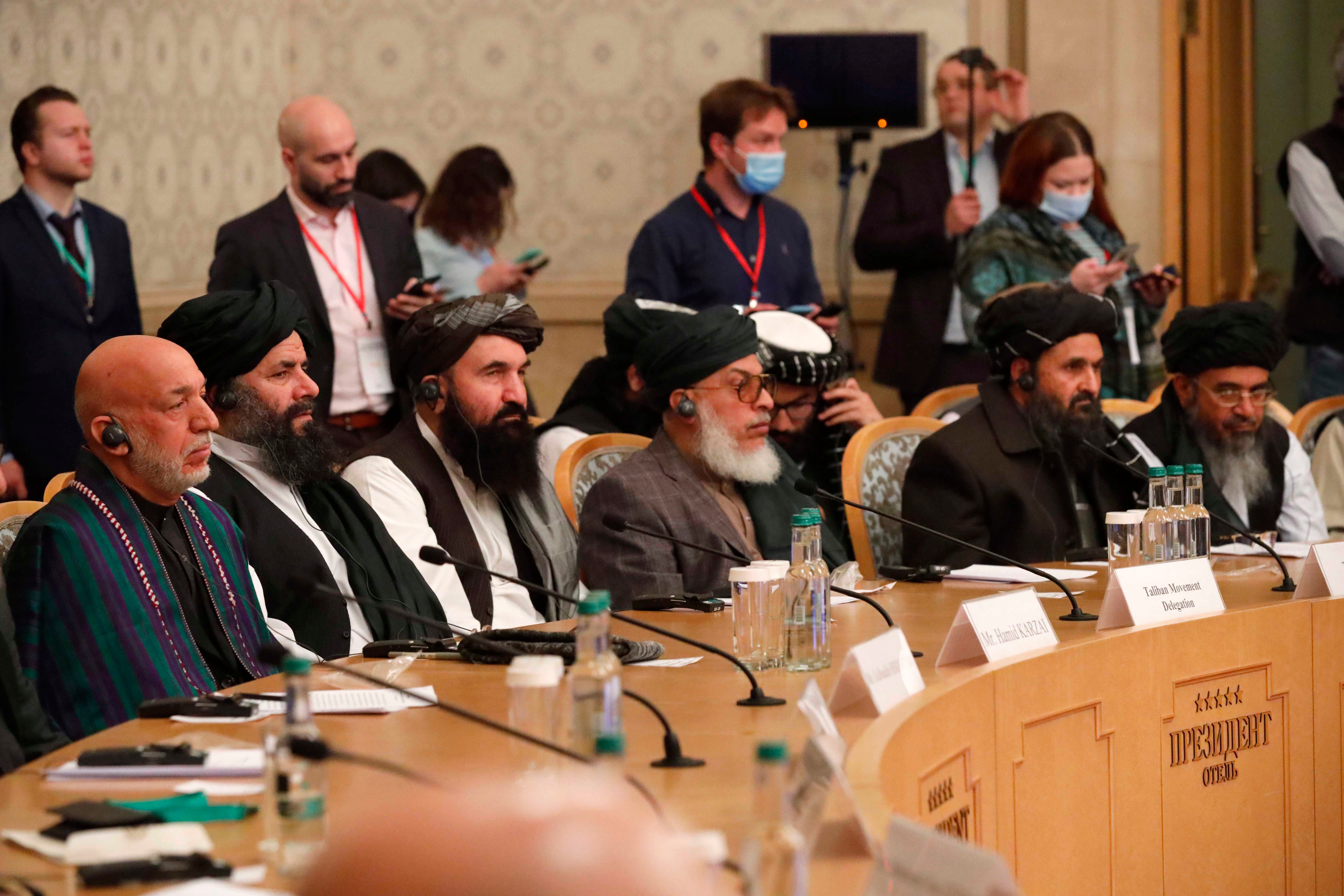 Former President Hamid Karzai, left, and Taliban co-founder Mullah Abdul Ghani Baradar, second right, attend an international peace conference in Moscow, Russia, March 18, 2021.