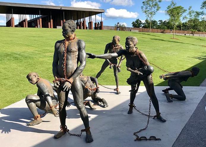 A sculpture of African slaves by Ghanaian artist, Kwame Akoto-Bamfo, at the beginning of the National Memorial for Peace and Justice in Montgomery, Alabama. 