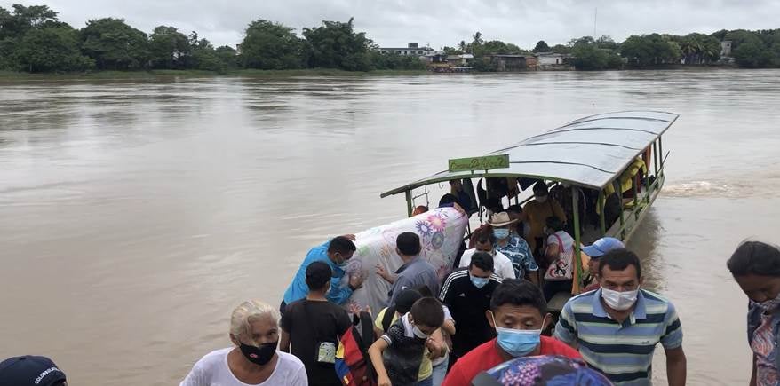 People disembark in Colombia after fleeing Venezuela's Apure state due to a Venezuelan military operation against armed groups in the region, as well as egregious abuses by Venezuelan security forces.