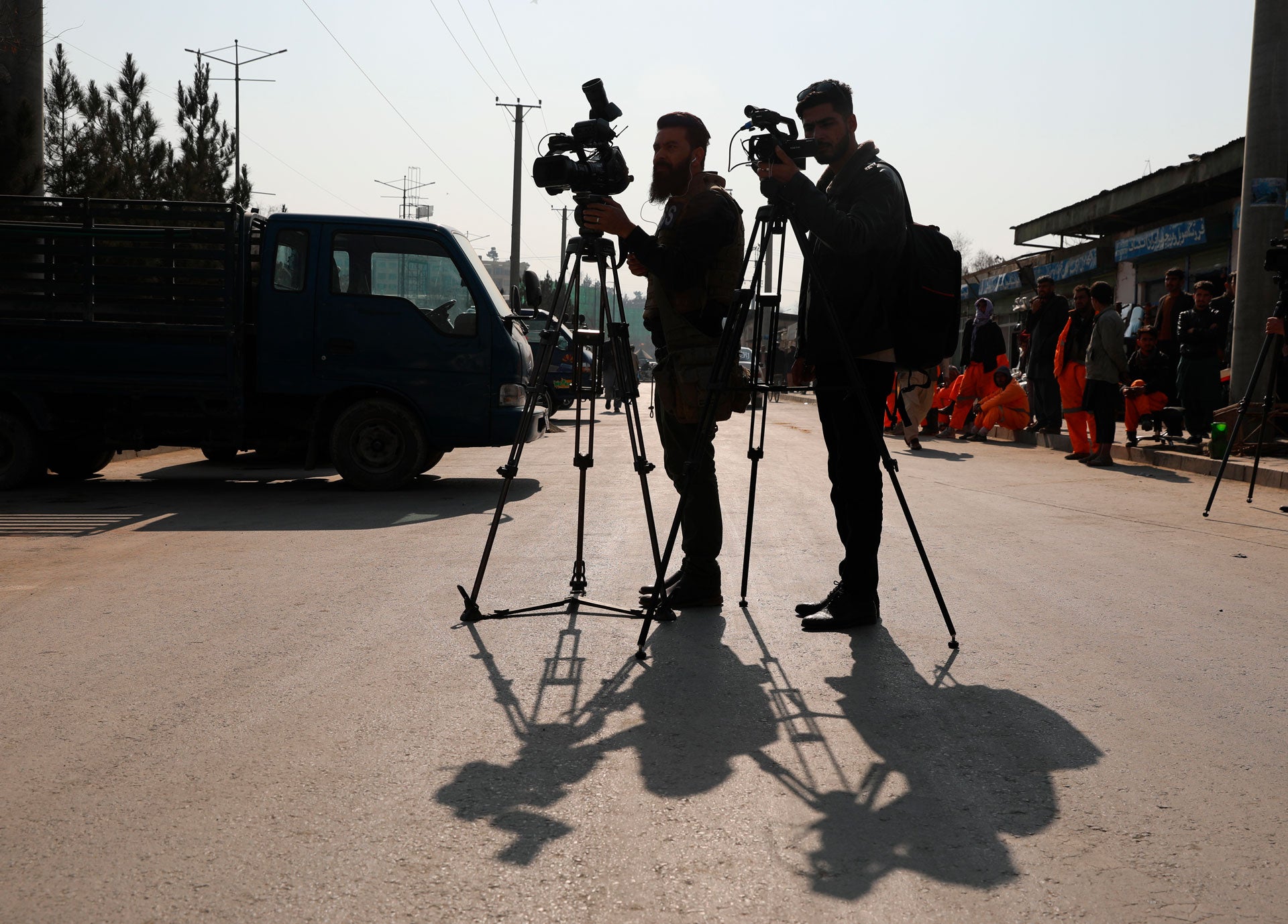 Afghan journalists film at the site of a bombing attack in Kabul, Afghanistan, Tuesday, Feb. 9, 2021. 