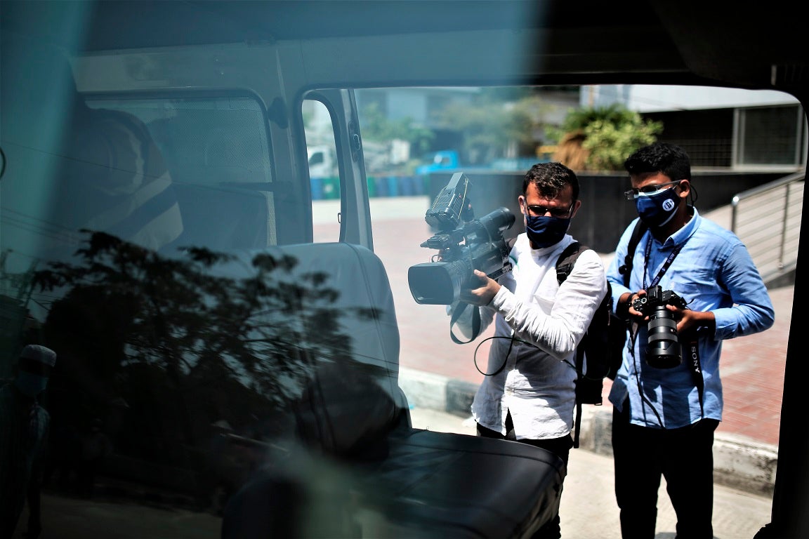 Journalists work in front of a Covid-19 Hospital in Dhaka, Bangladesh on April 20, 2021. 