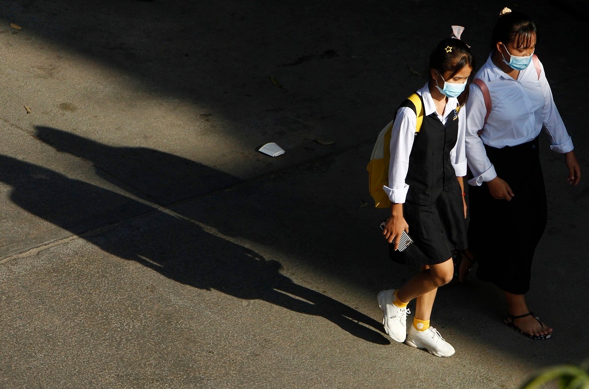 Cambodian school girls walk home at the end of their school day outside Phnom Penh, Cambodia.