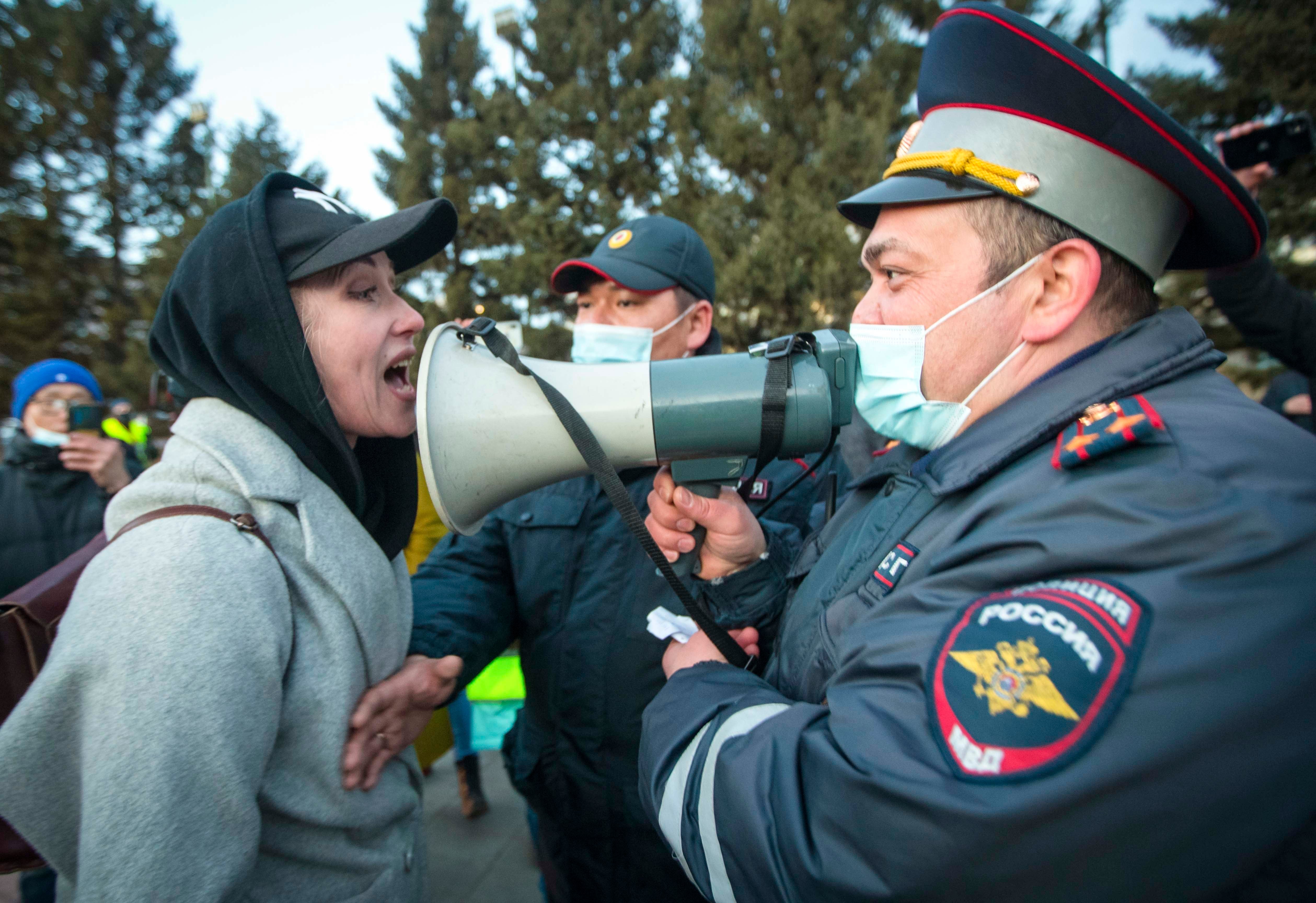 A woman argues with a police officer during a protest in support of jailed opposition leader Alexei Navalny in Ulan-Ude, Russia, April 21, 2021.