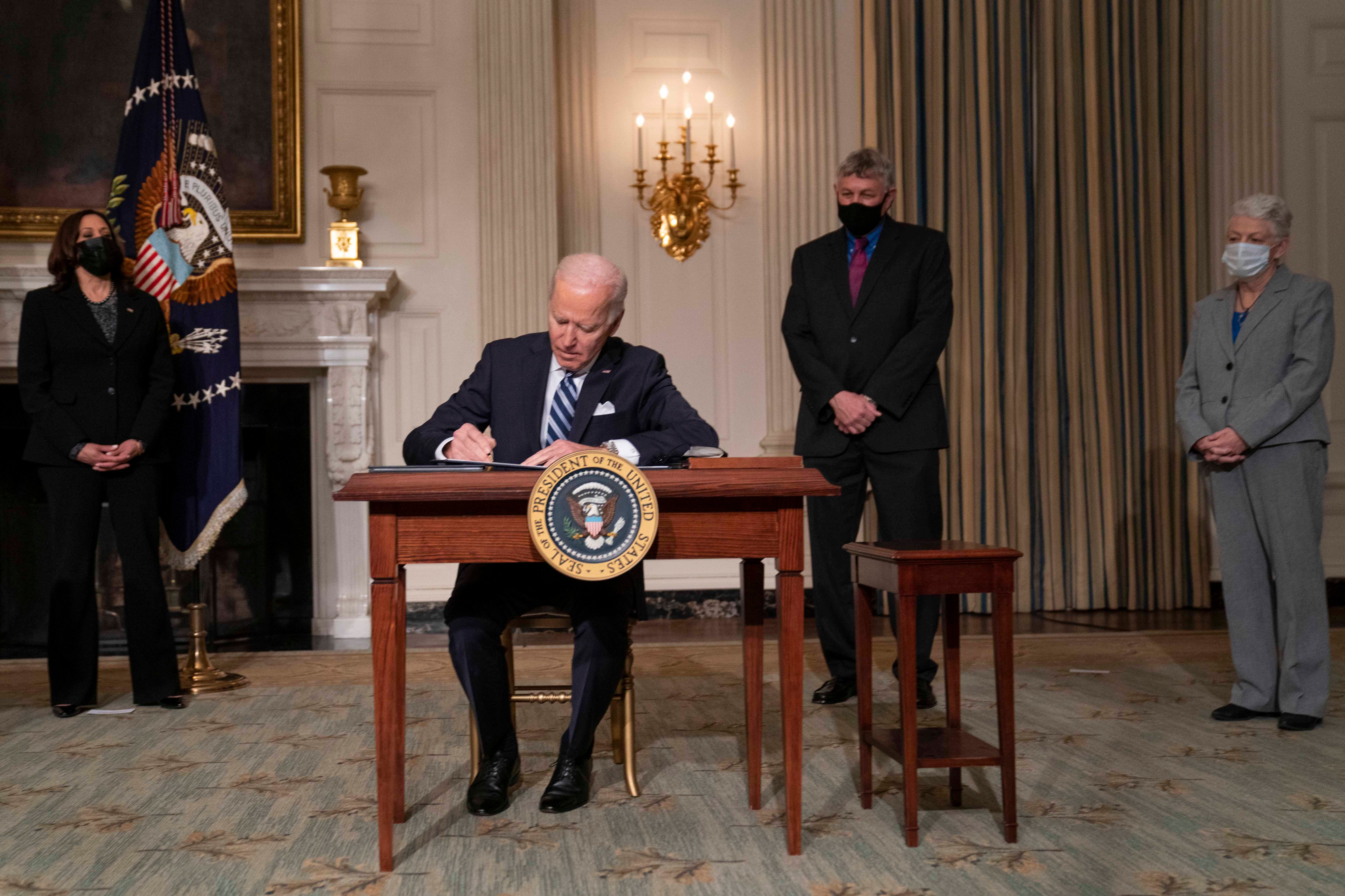 US President Joe Biden signs a series of executive orders on tackling climate change on January 27, 2021 in Washington, DC.