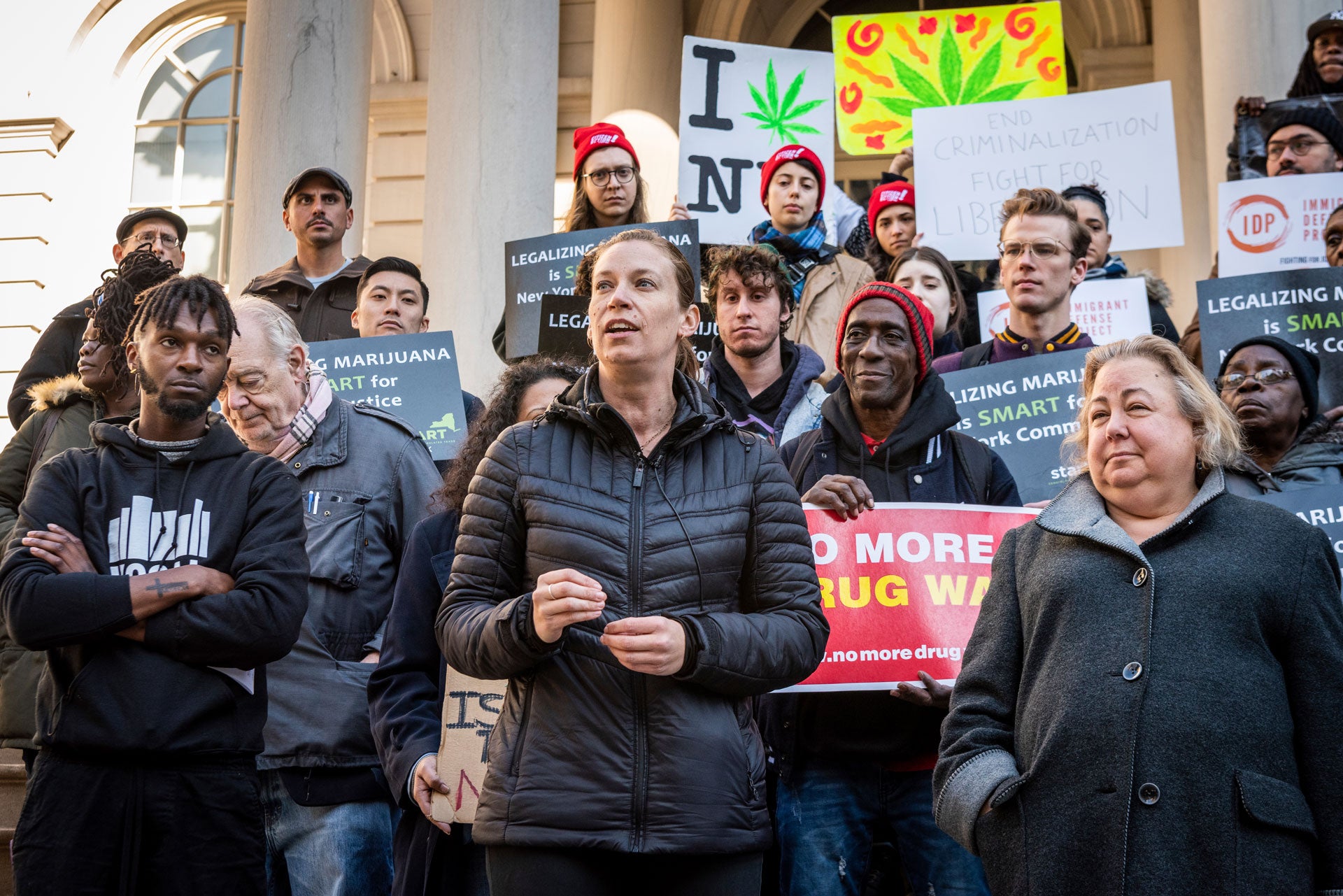 Supporters of the Marijuana Regulation and Taxation Act (MRTA) rally on the steps of New York City Hall with signs