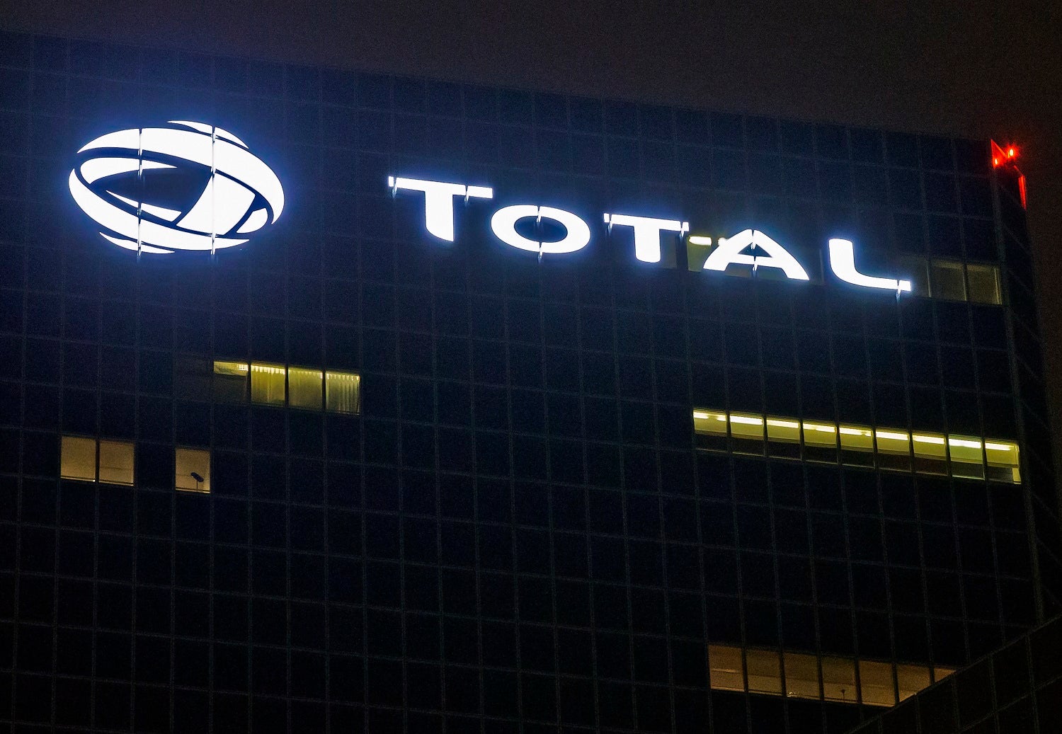 Le logo de l’entreprise pétrolière Total SA, visible sur la façade du siège de la compagnie dans le quartier d'affaires de La Défense, dans la banlieue nord-ouest de Paris. 