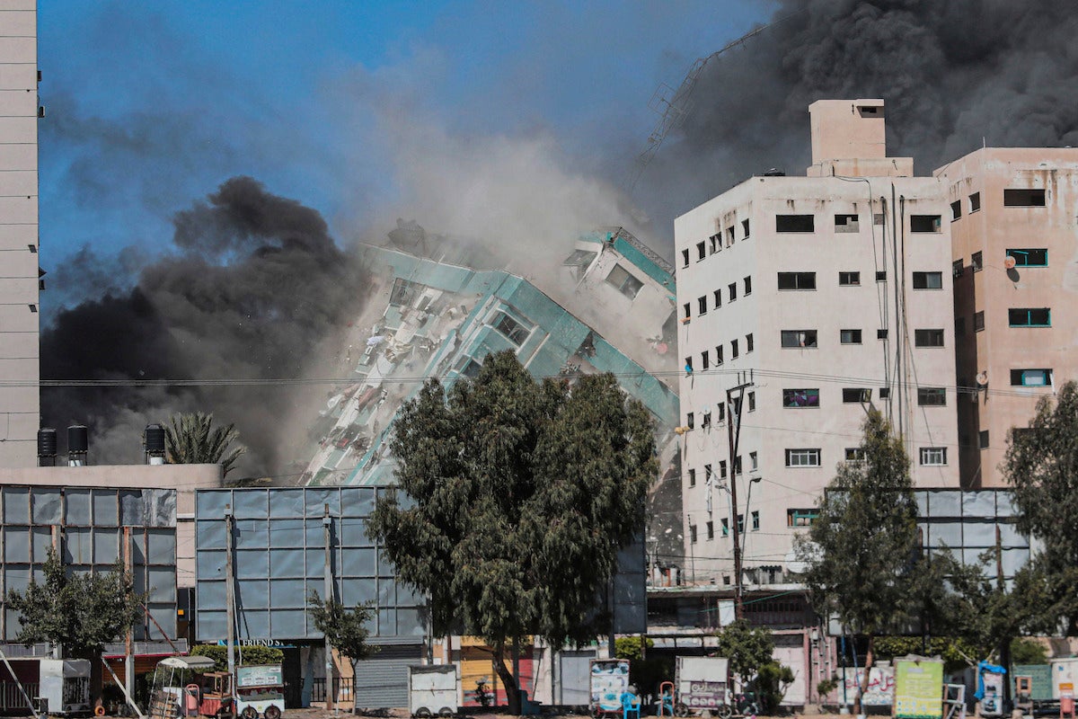The Jala Tower as it is destroyed in an Israeli airstrike in Gaza. Israel's air force targeted the 13-floor Jala Tower housing Qatar-based Al-Jazeera television and the Associated Press news agency.
