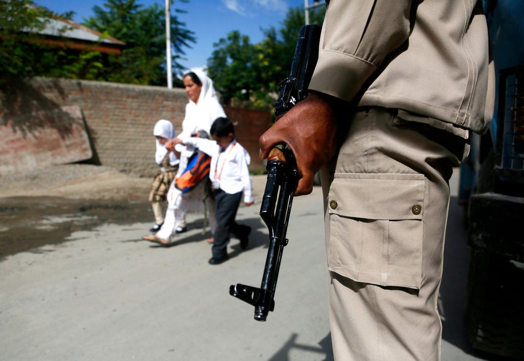 An Indian paramilitary soldier stands guard during a search operation in Srinagar, Kashmir, in August 2018.