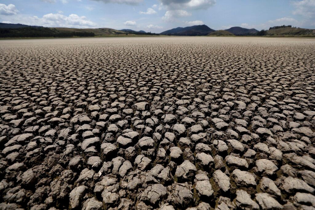 After years of very little rainfall, the lakebed of Suesca lagoon sits dry and cracked, in Suesca, Colombia, Wednesday, Feb. 17, 2021. 