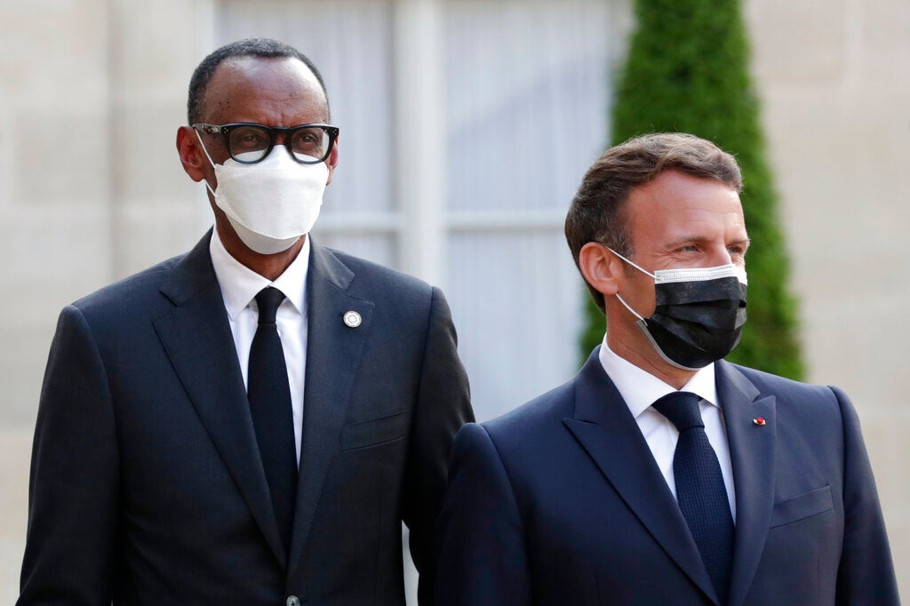 French President Emmanuel Macron, right, welcomes Rwanda President Paul Kagame at a dinner for leaders of African states, at the Elysee Palace, Paris, May 17, 2021.