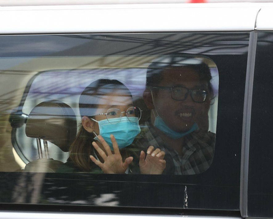 Mother Nature Cambodia activist Sun Ratha waves to her family as she is brought to the Phnom Penh Municipal Court on June 19, 2021. (c) 2021 LICADHO