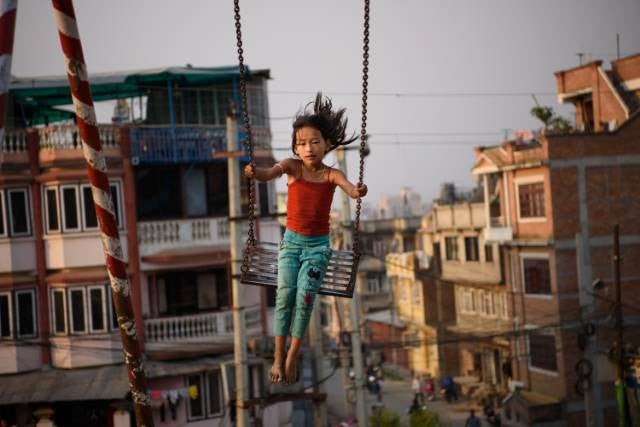 A girl plays in a public park in Patan, Nepal. Thirty-seven percent of girls in Nepal marry before age 18, and 10 percent are married by age 15. The minimum age of marriage under Nepali law is 20 years of age. April 24, 2016.