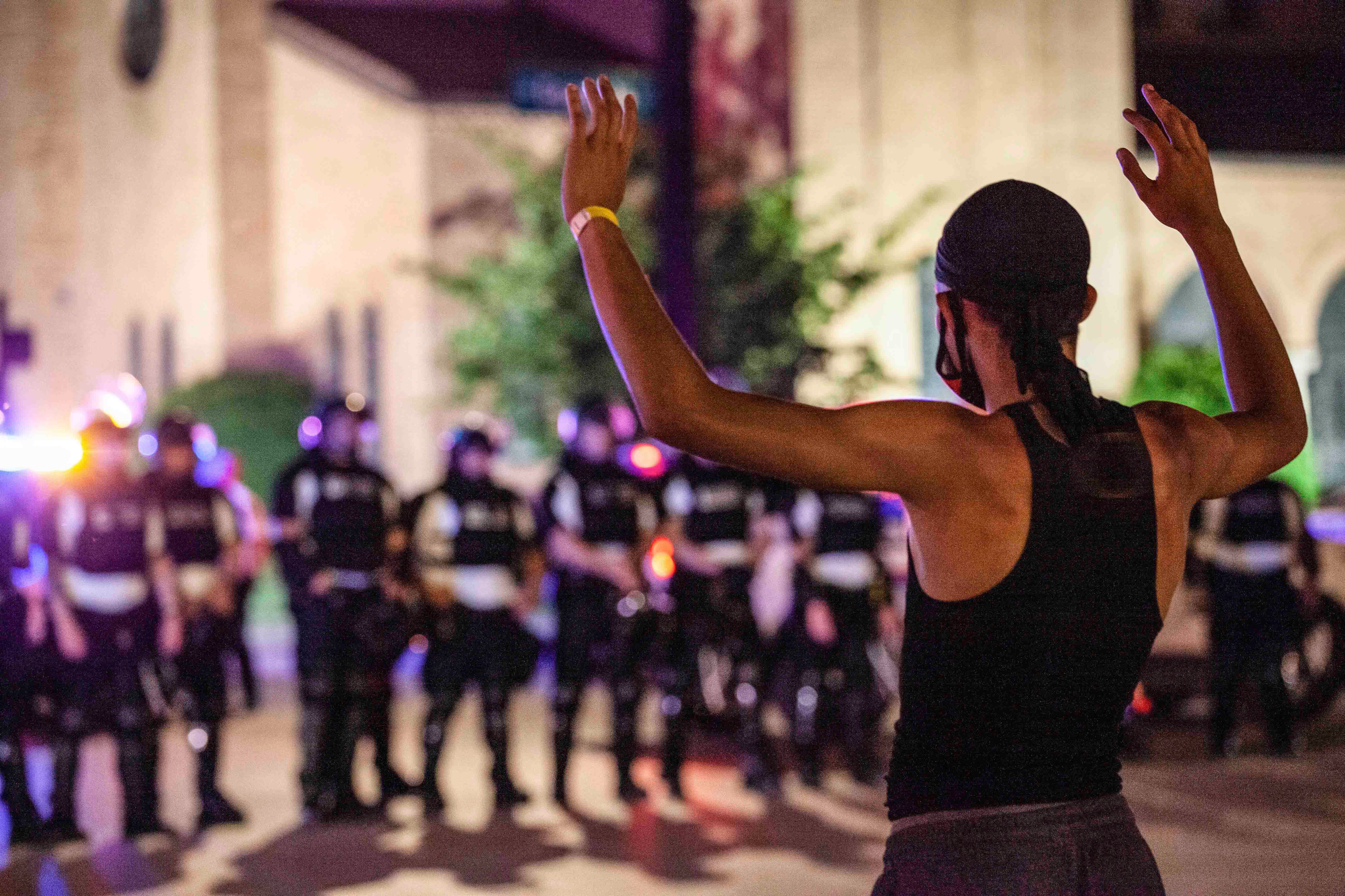 A protester puts his hands up in front of a line of police in riot gear in the US city of Columbus, Ohio, on June 5, 2020.