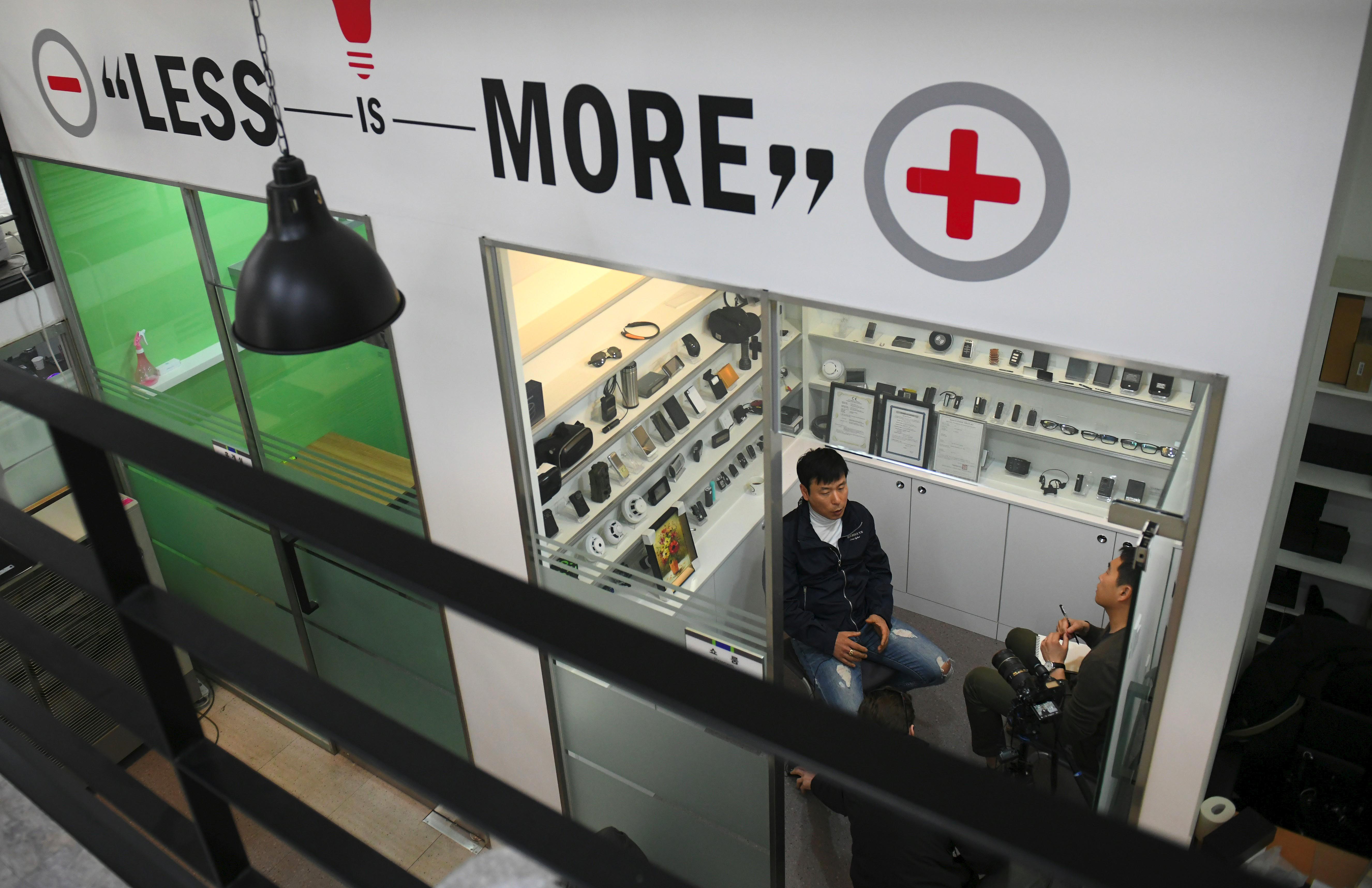 An overhead shot of a man being interviewed in a store