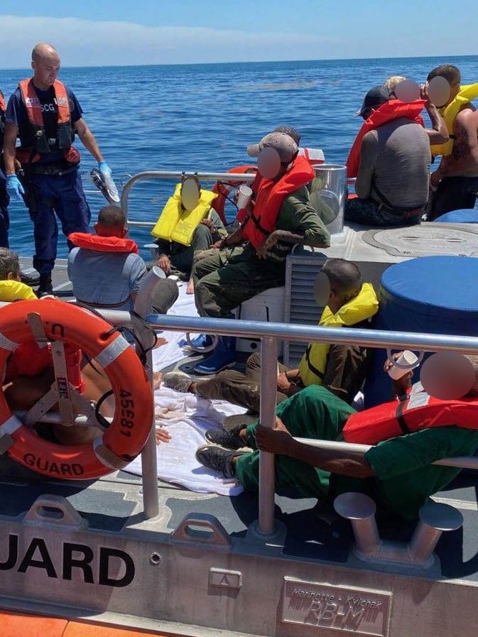 A Coast Guard Station Marathon boat crew and 15 migrants aboard 45-foot Response Boat-Medium near Big Pine Key, Florida on July 3, 2021. Photo by Petty Officer 3rd Class Ryan Estrada. Source: United States Coast Guard