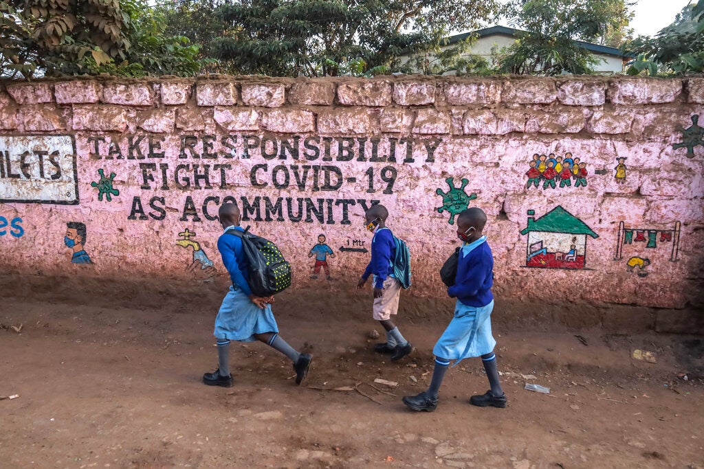 Pupils wearing facemasks head to school following the reopening of schools after nine months of no school due to the coronavirus pandemic in Nairobi, Kenya, January 4, 2021.