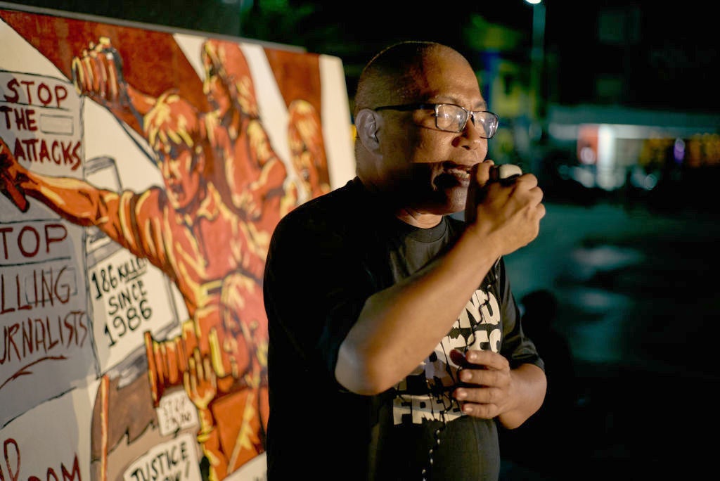 National Union of Journalists of the Philippines chairman Nonoy Espina speaks to other journalists and activists as they gather to hold a vigil on the eve of the promulgation of the Maguindanao massacre trial on December 18, 2019 in Manila, Philippines.