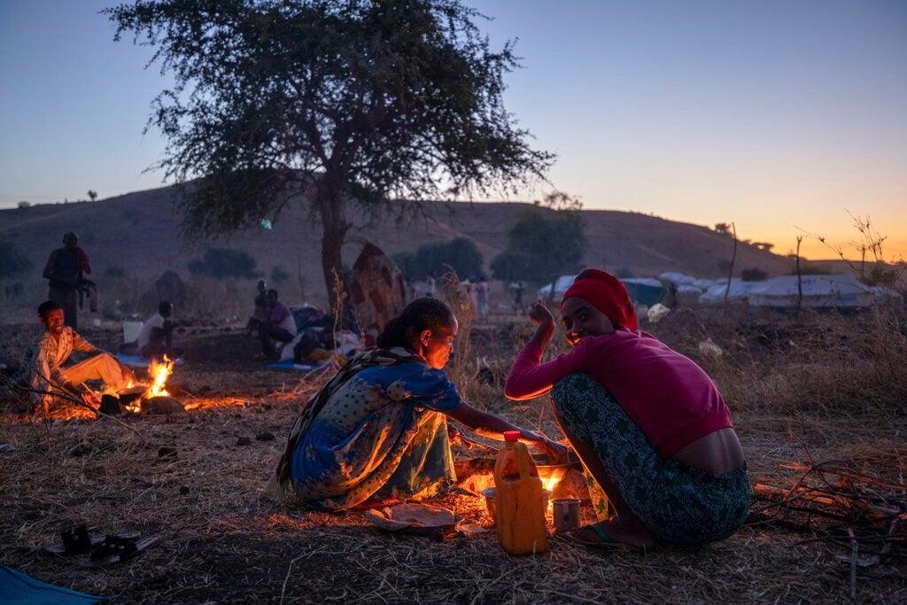 Tigrinyan refugee women prepare bread for their family in Umm Rakouba refugee camp in Qadarif, eastern Sudan on December 11, 2020 