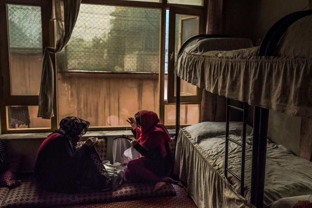 Afghan women sew in their bedroom at a women's shelter in Kabul, March 20, 2017. A non-descript building tucked away in a residential neighborhood is one of the few hidden sanctuaries where battered women can seek support. 