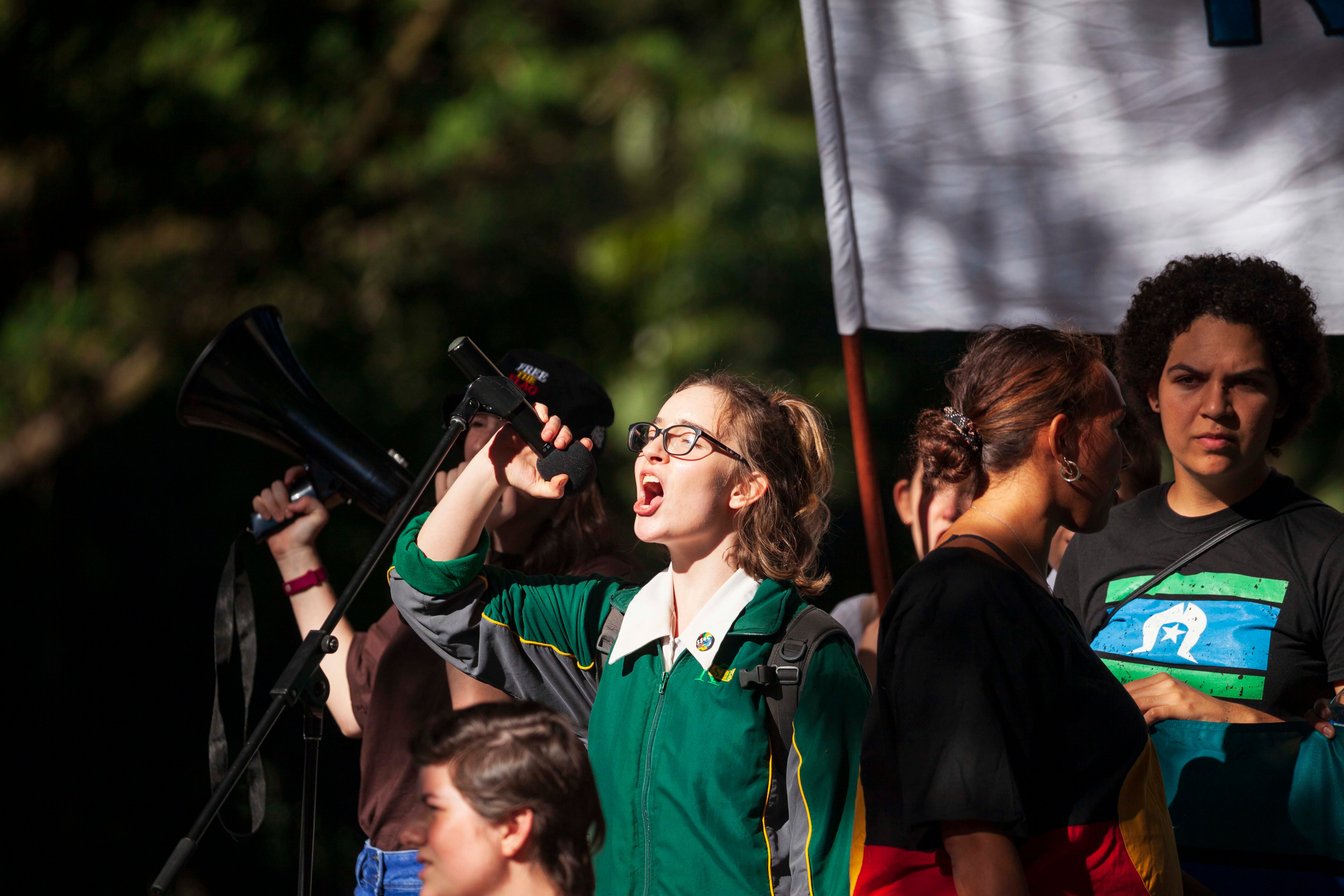 A student protester speaks to the crowd during a climate change protest in Brisbane.