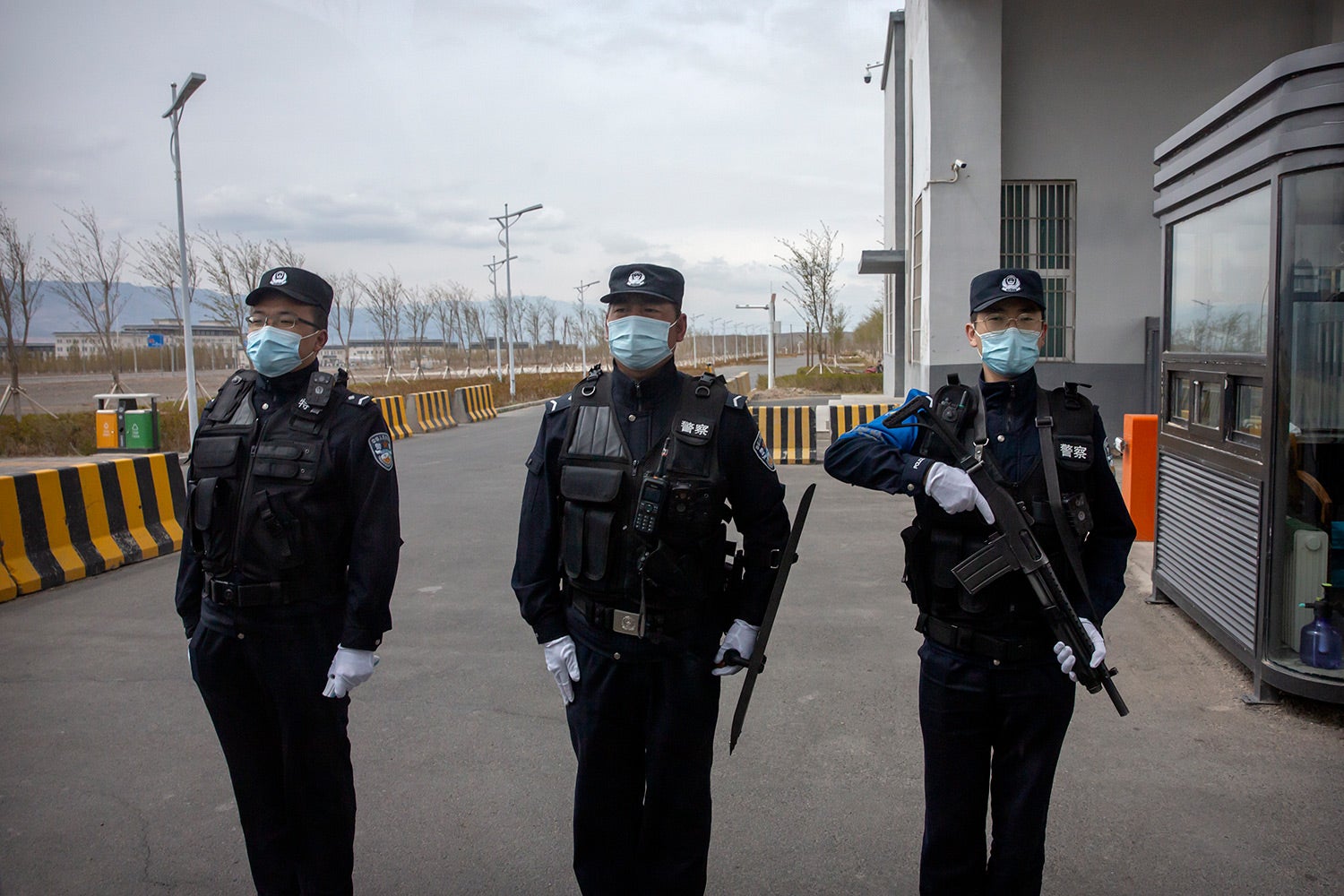 Police officers stand at the outer entrance of the Urumqi No. 3 Detention Center in Dabancheng in western China's Xinjiang region on April 23, 2021.