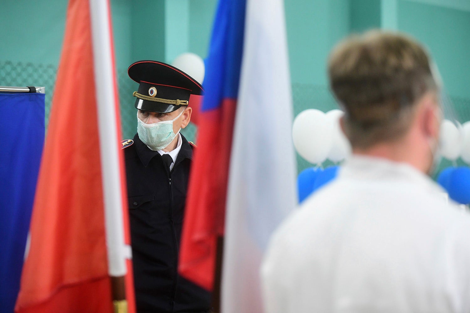 Police officer wearing face mask stands on duty at the polling station on July 1, 2020 in St. Petersburg, Russia.