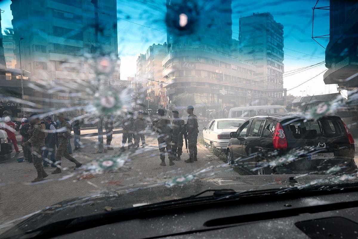 Lebanese army soldiers are seen through the bullet-riddled window of a car after deadly clashes erupted in Beirut, Lebanon, Thursday, Oct. 14, 2021.