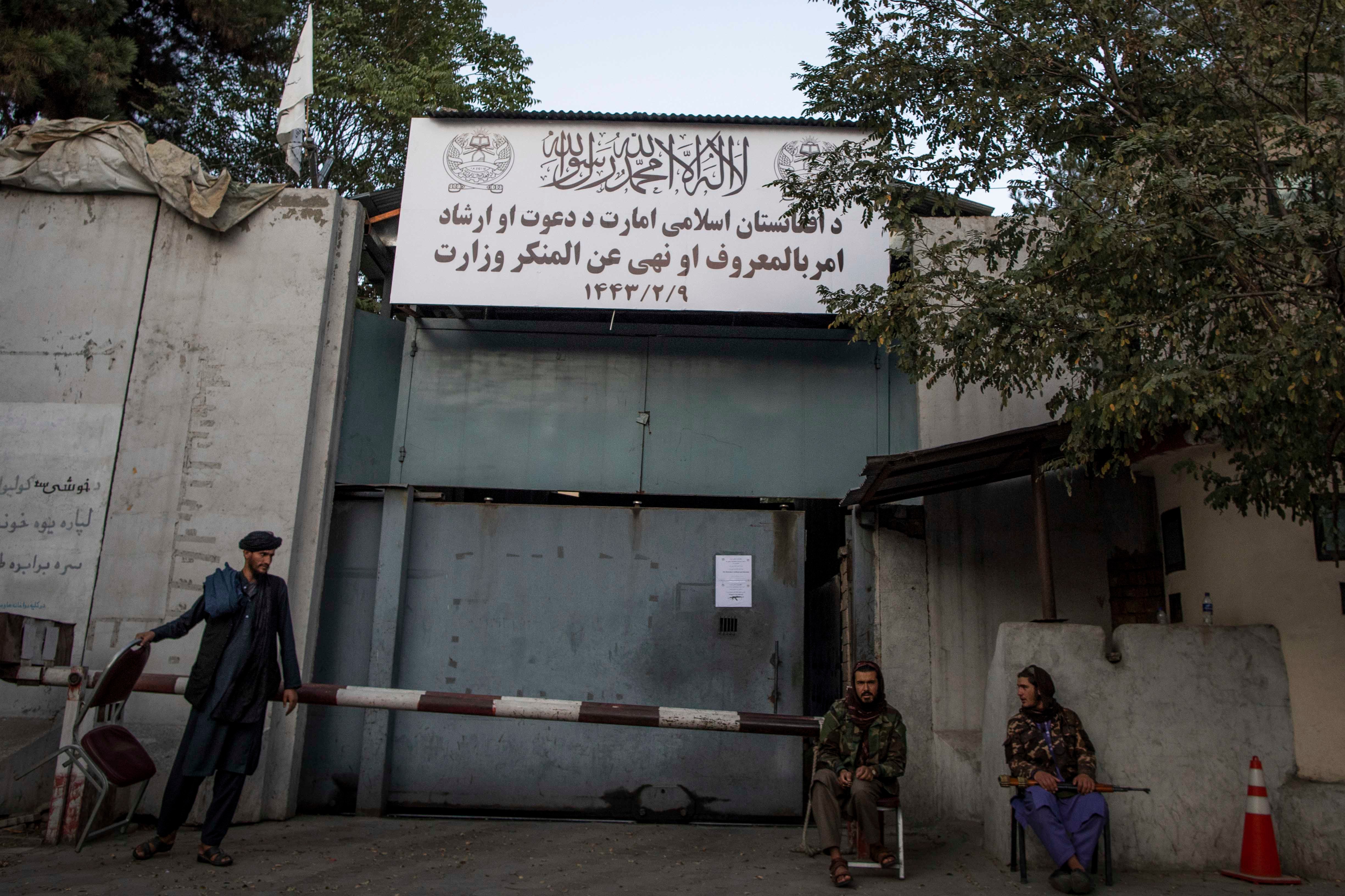 Taliban fighters stand guard at the entrance to the former Ministry of Women Affairs, which the Taliban has replaced with the Ministry of Vice and Virtue, which oversees the implementation of hardline Islamic rules in Afghanistan.