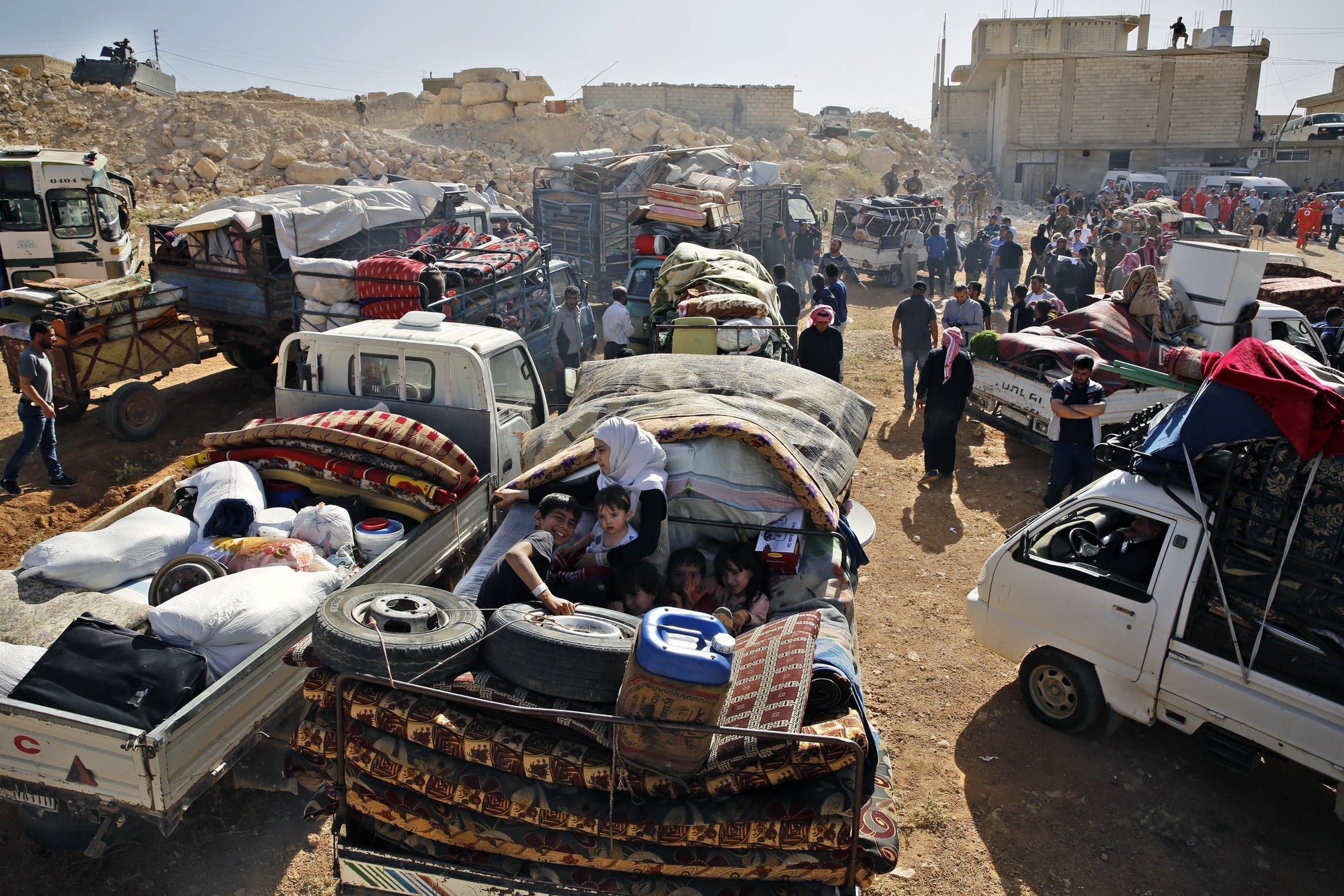 Syrian refugees gather in their vehicles getting ready to cross into Syria from the eastern Lebanese border town of Arsal, Lebanon, on June 28, 2018.