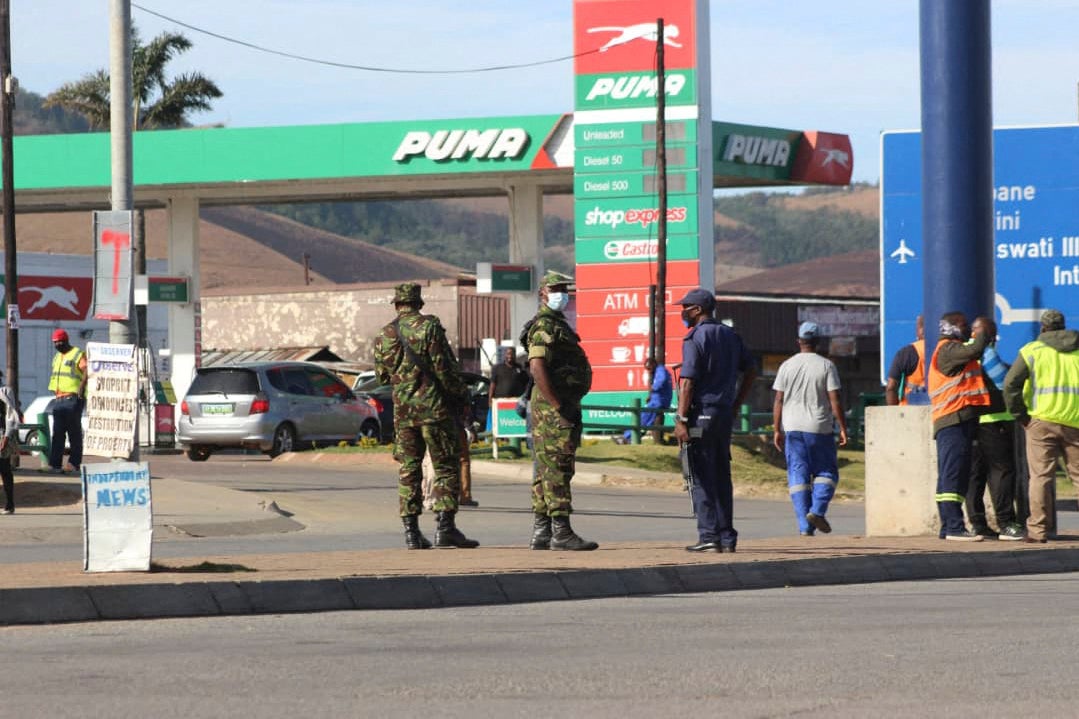 Eswatini soldiers and police officers are seen on the streets near the Oshoek Border Post between Eswatini and South Africa on July 1, 2021.