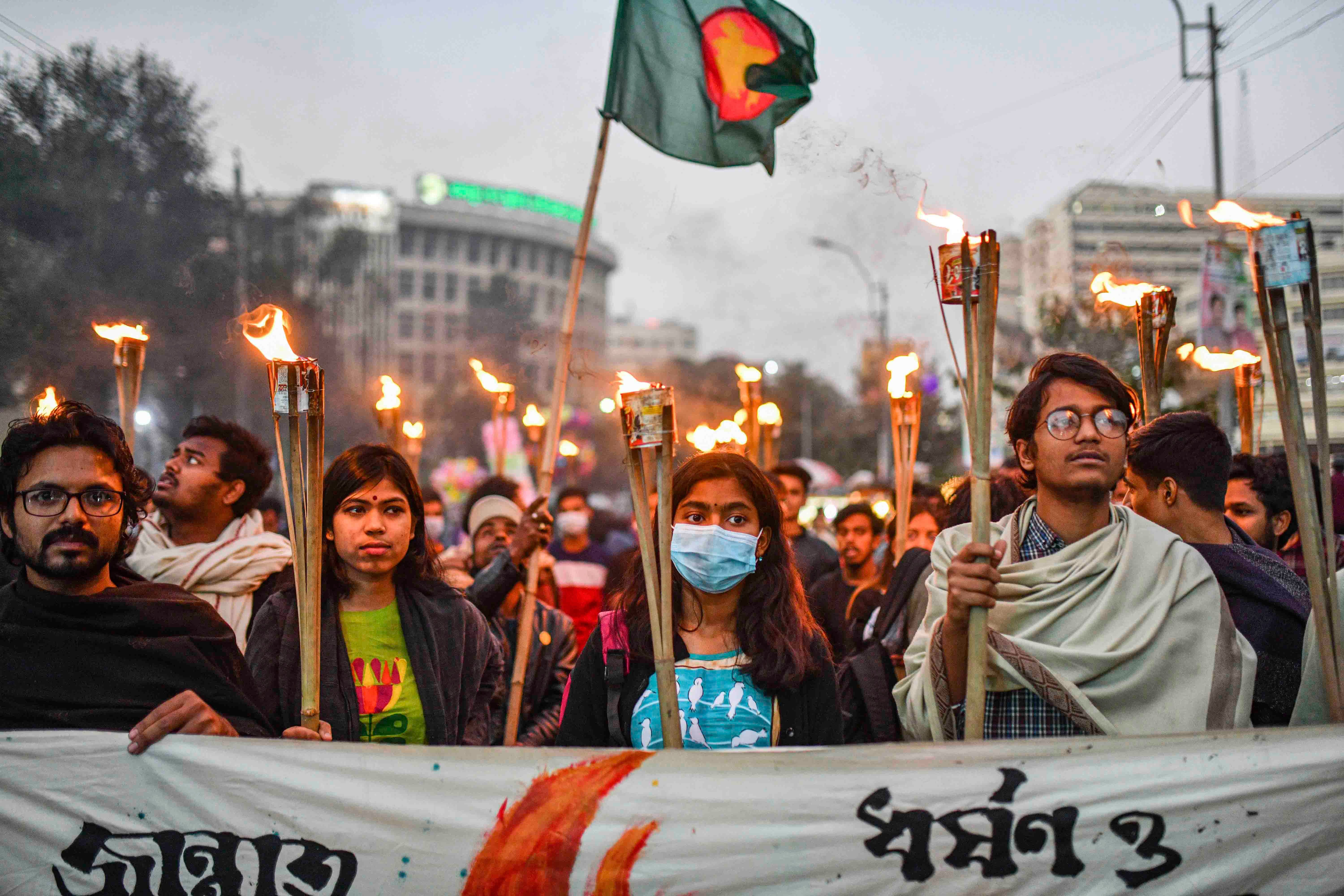 Students and activists take part in a torch procession demanding for the government to take action against murder and rape in Bangladesh.