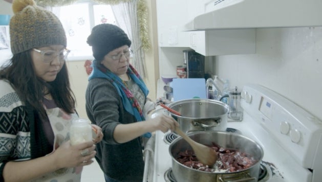 Georgina Wabano and her mother cooking traditional food for school children in Peawanuck, ON, December 18, 2019. : © 2019 Daron Donahue