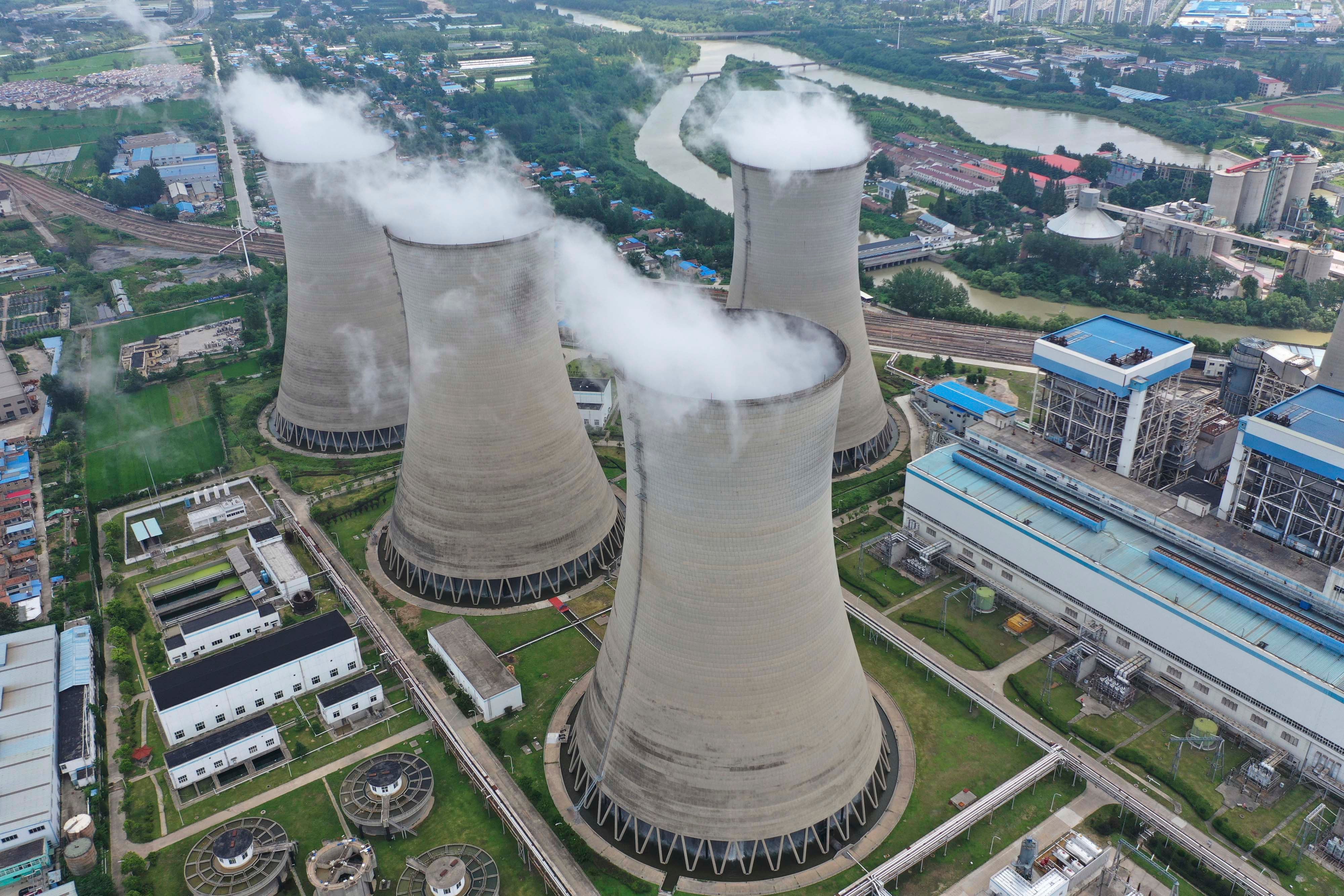 Steam billows out of the cooling towers of a coal-fired power plant in Huai'an in east China's Jiangsu province, July 20, 2021.