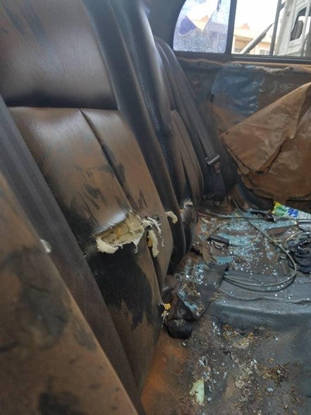 Damage to the interior of a car, including broken windows