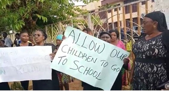 Women protesters holding signs