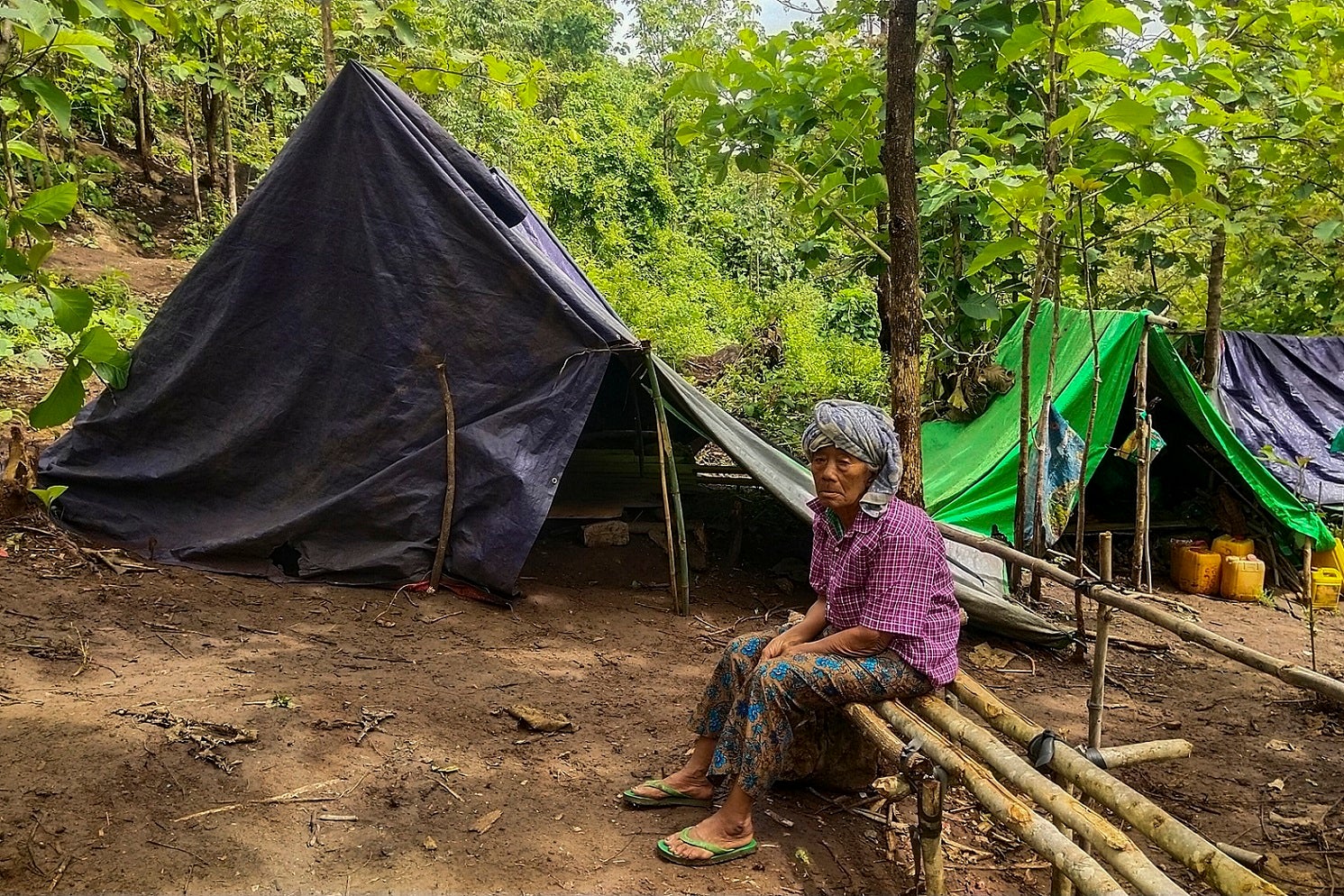 A man sits at a makeshift displacement site in Demoso township, Karenni State, June 17, 2021.