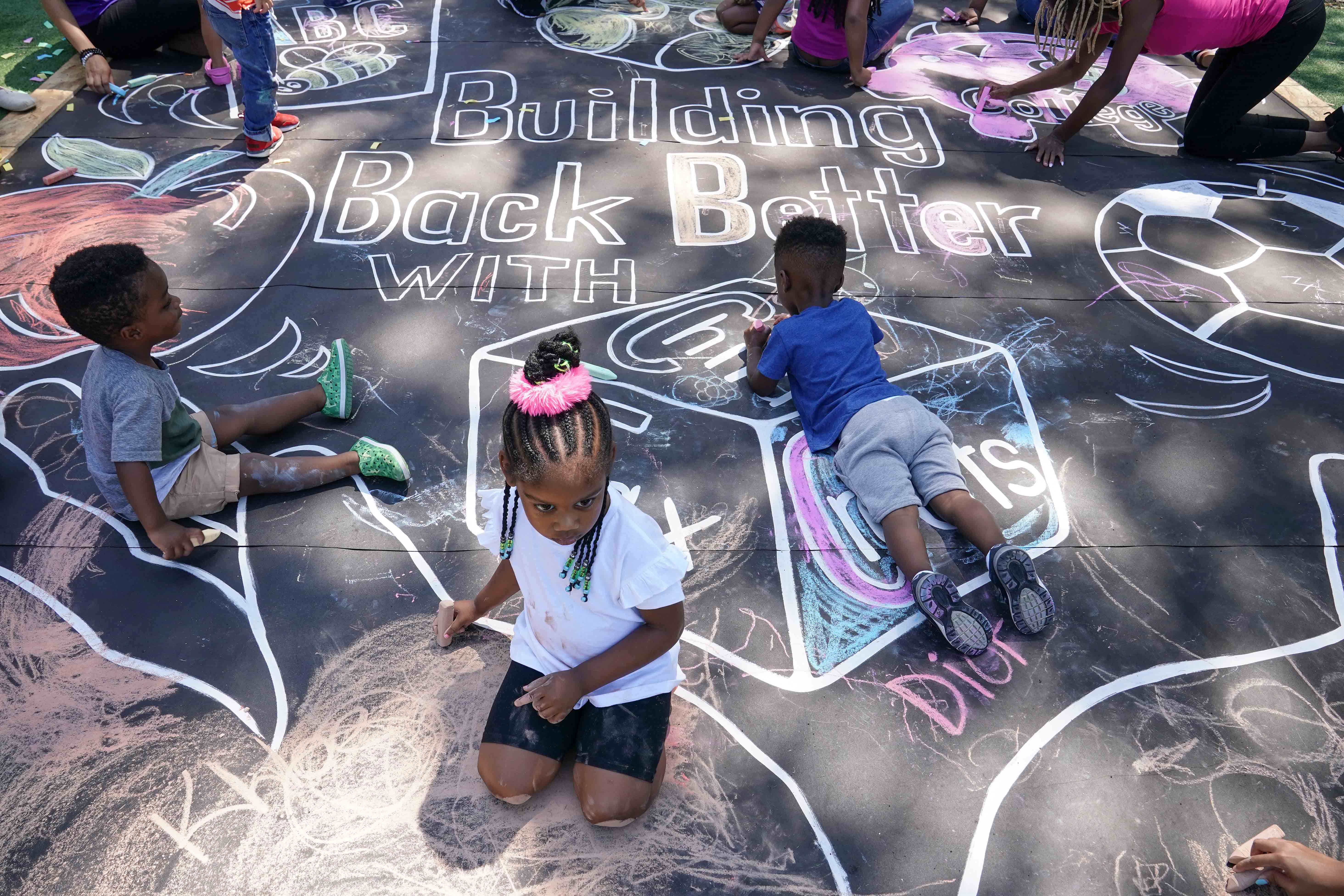 Children and teachers complete a mural in celebration of the launch of the Child Tax Credit on July 14, 2021 at the KU Kids Deanwood Childcare Center in Washington, DC.