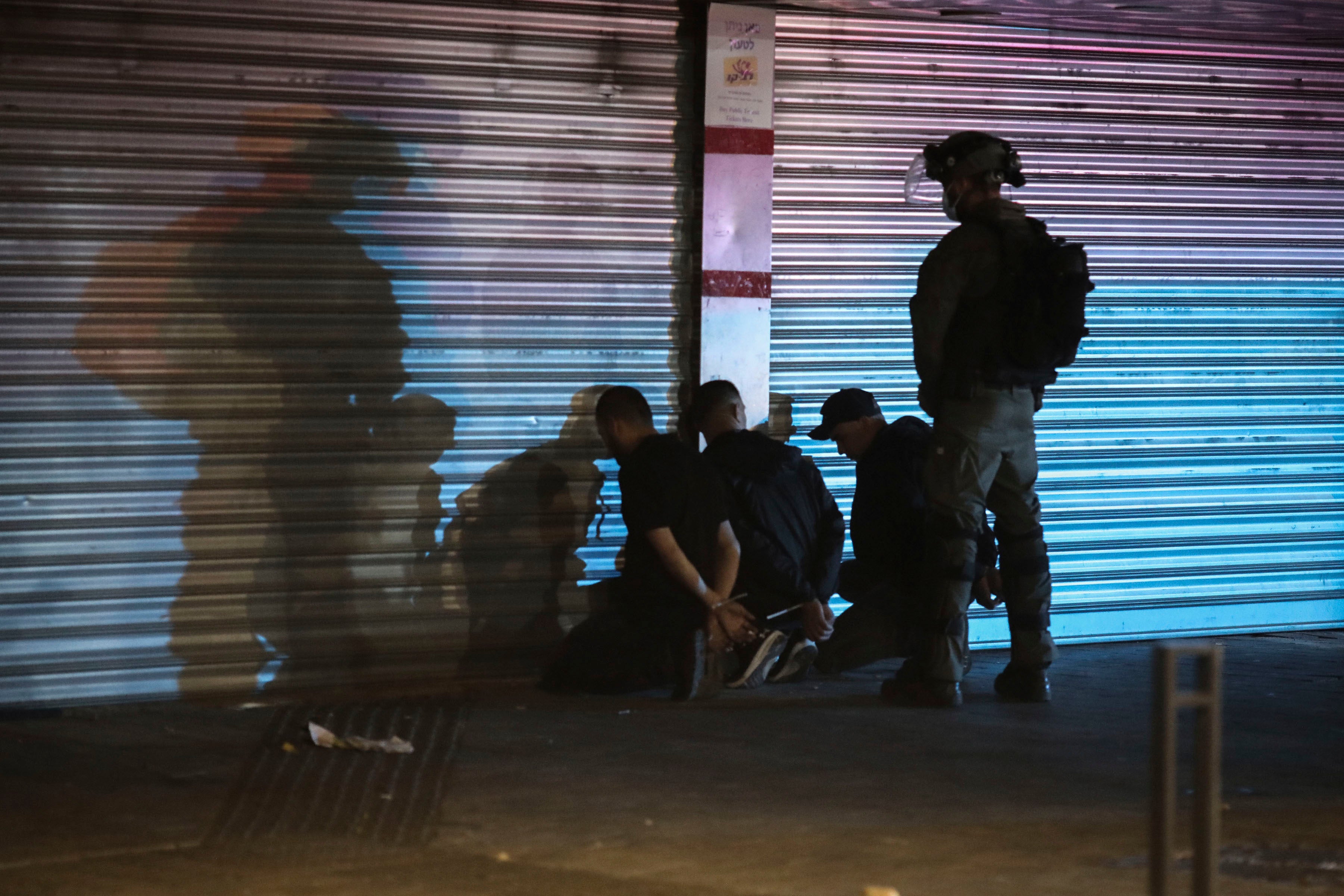 Israeli forces detain three Palestinians on May 13, 2021 during unrest in Lod, a mixed Jewish and Palestinian city in central Israel.