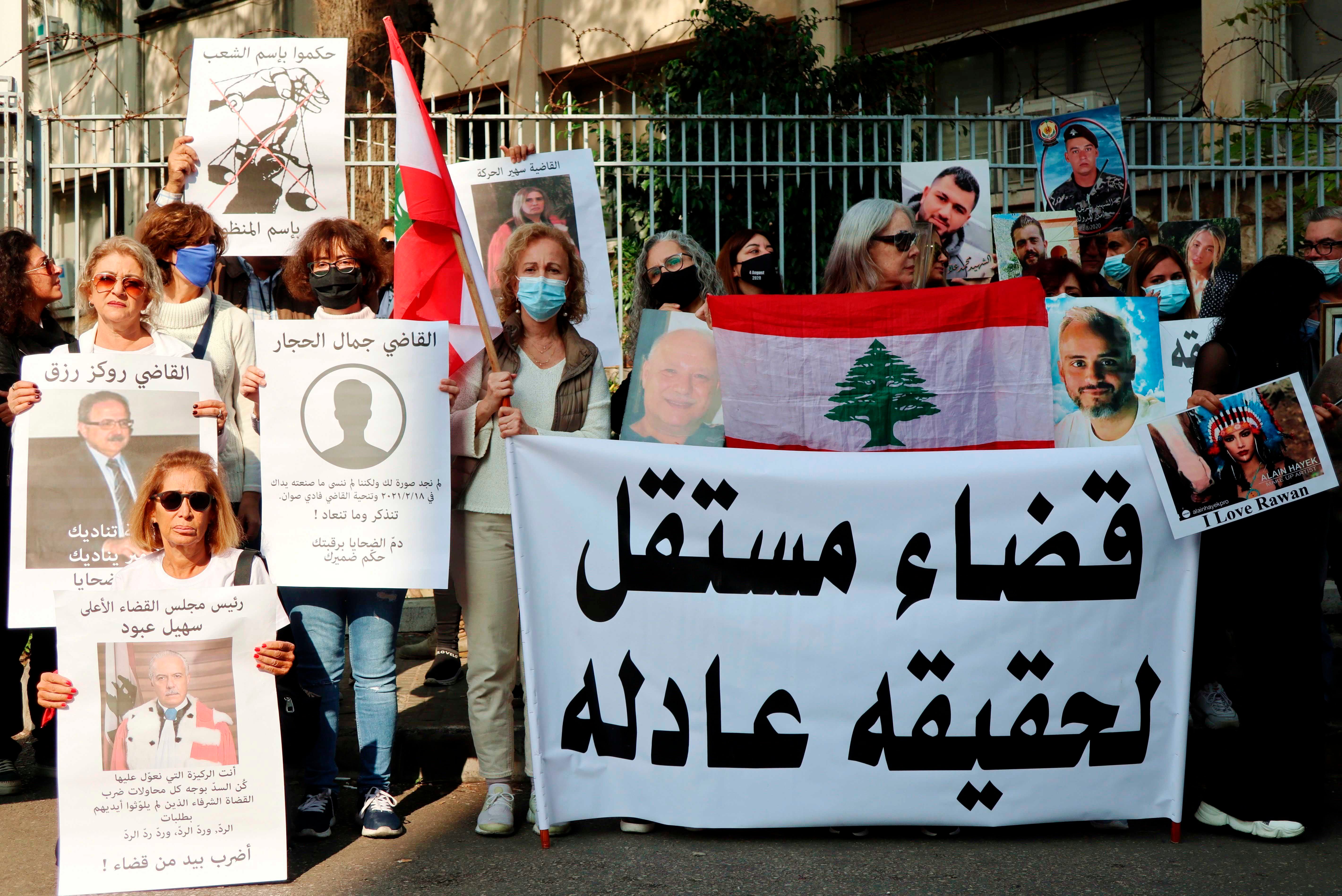 Families of Port Blast's victims show portraits of their beloved ones near the Palace of Justice in Beirut, November 25, 2021. Relatives of victims call for an independent judiciary to achieve justice.