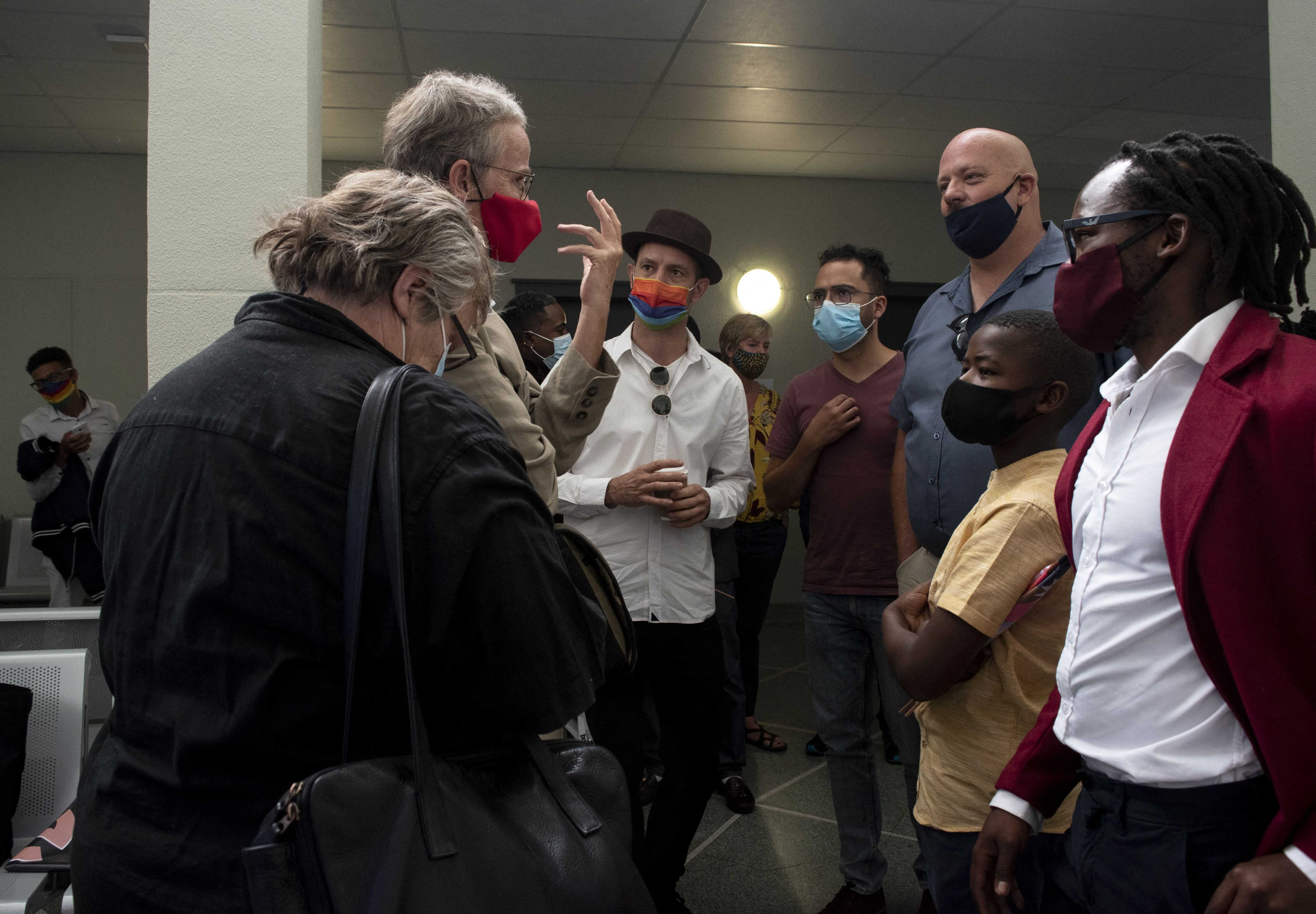 A group of men and women wearing face masks