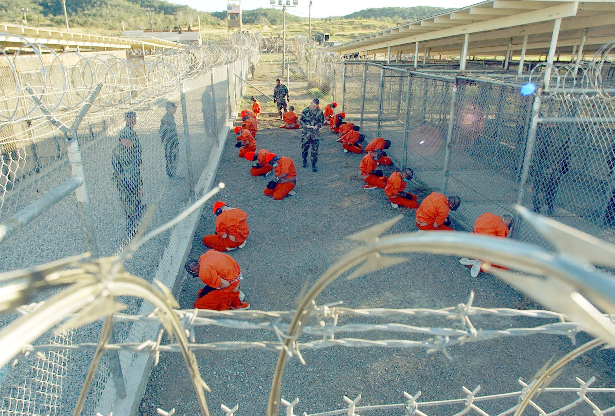 The first foreign Muslim men imprisoned by the US military at the detention center at Guantánamo Bay, Cuba, in the so-called “global war on terror.” Since January 2002, the US has held nearly 800 men and boys at Guantánamo. Of the 39 who currently remain, 27 have never been charged. © 2002 Shane McCoy/Greg Mathieson/Mai/Getty Images